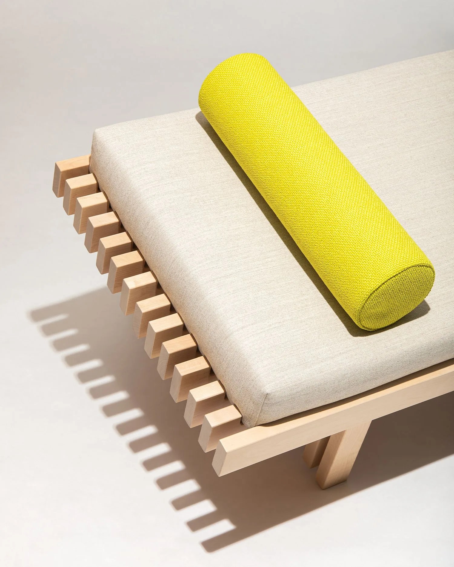 close up of a wooden bench with pillows