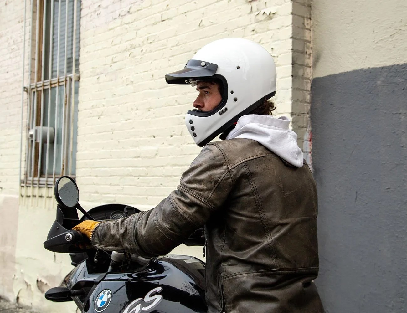 a man wearing a motorcycle helmet on a bike