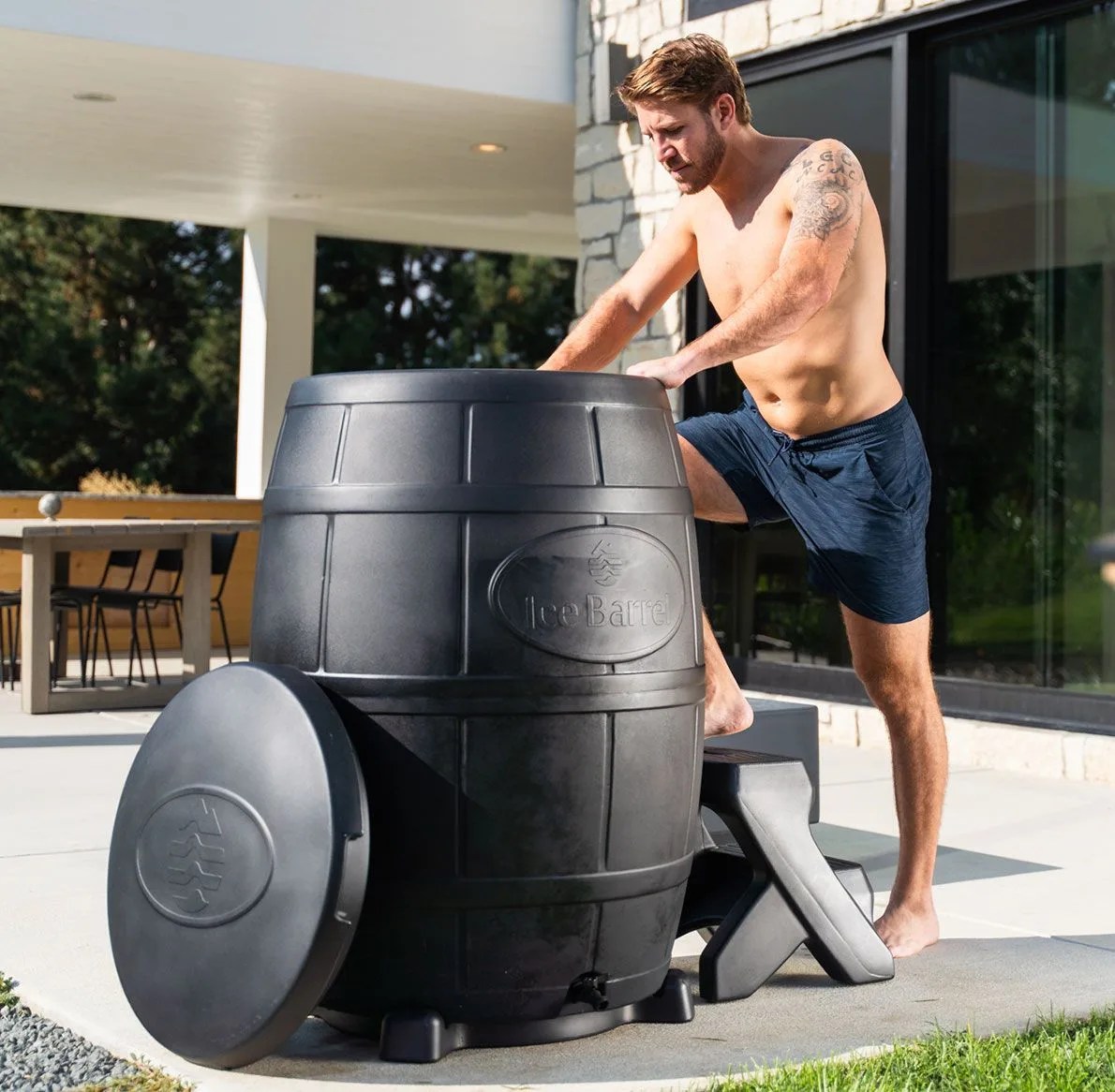 a man stepping into an ice barrel