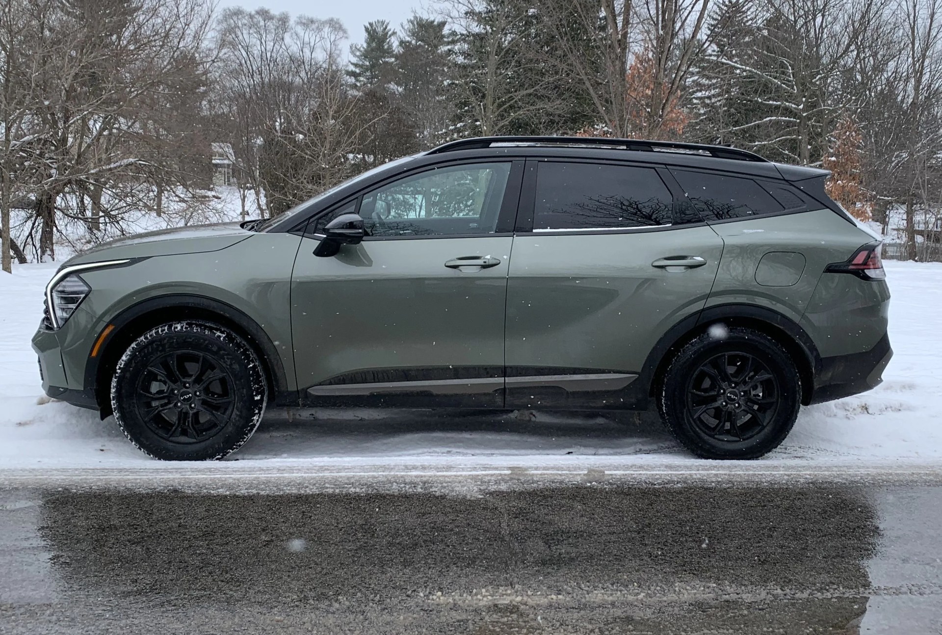 kia sportage in front of a snow covered park