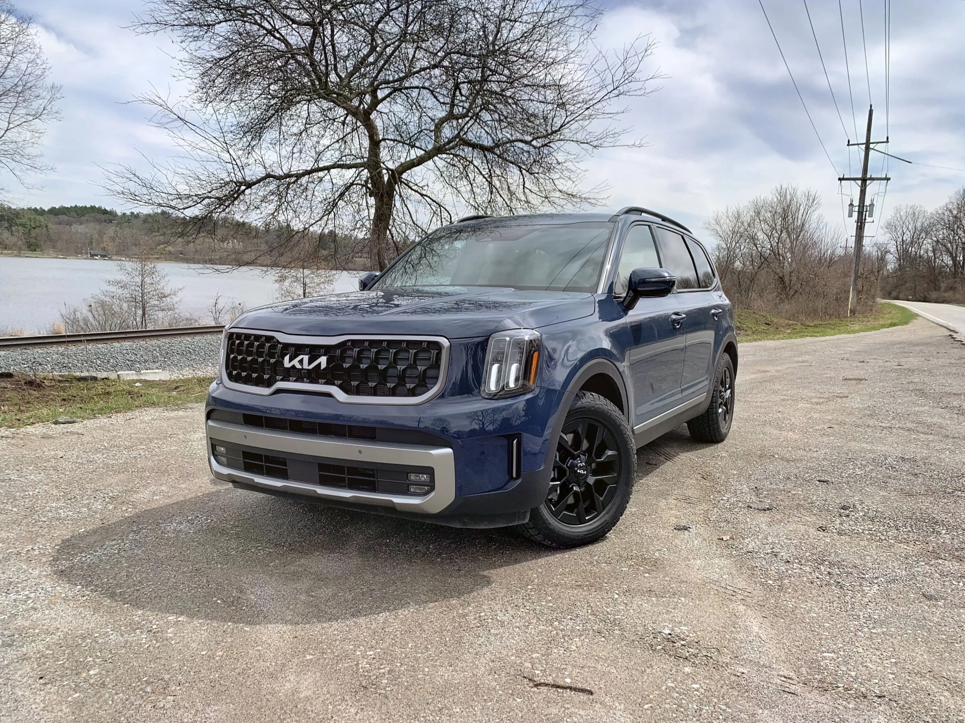 kia telluride x pro parked next to a river and train tracks
