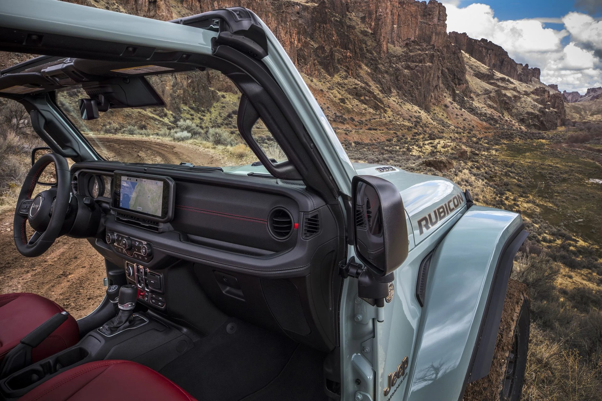 new 2024 jeep® wrangler rubicon x 4xe with 12 way power adjustable front seats and all new instrument panel featuring uconnect 5 system with best in class 123 inch touchscreen radio
