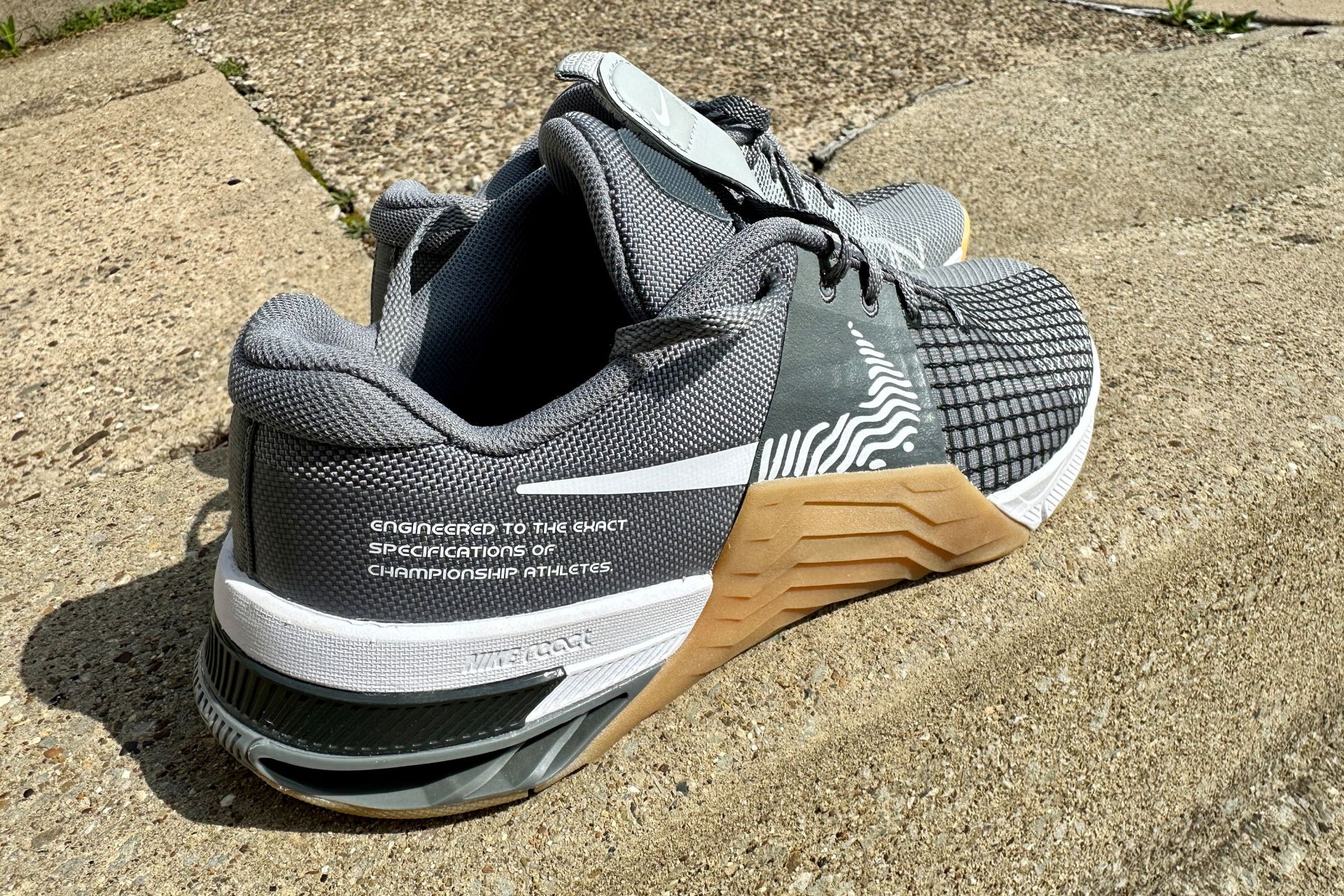 nike shoes sitting on a sidewalk