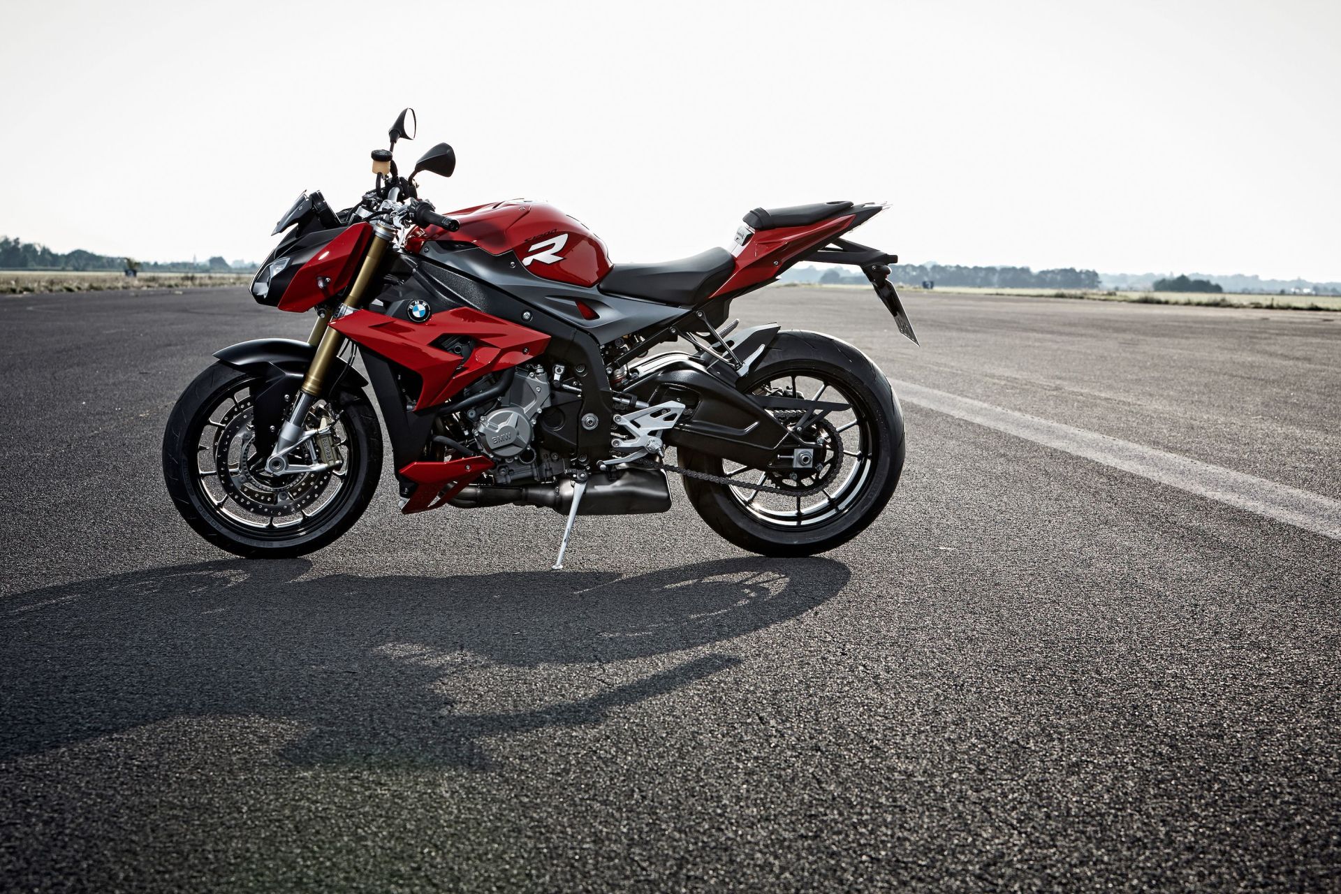 bmw s 1000 r motorcycle parked on an airplane tarmac