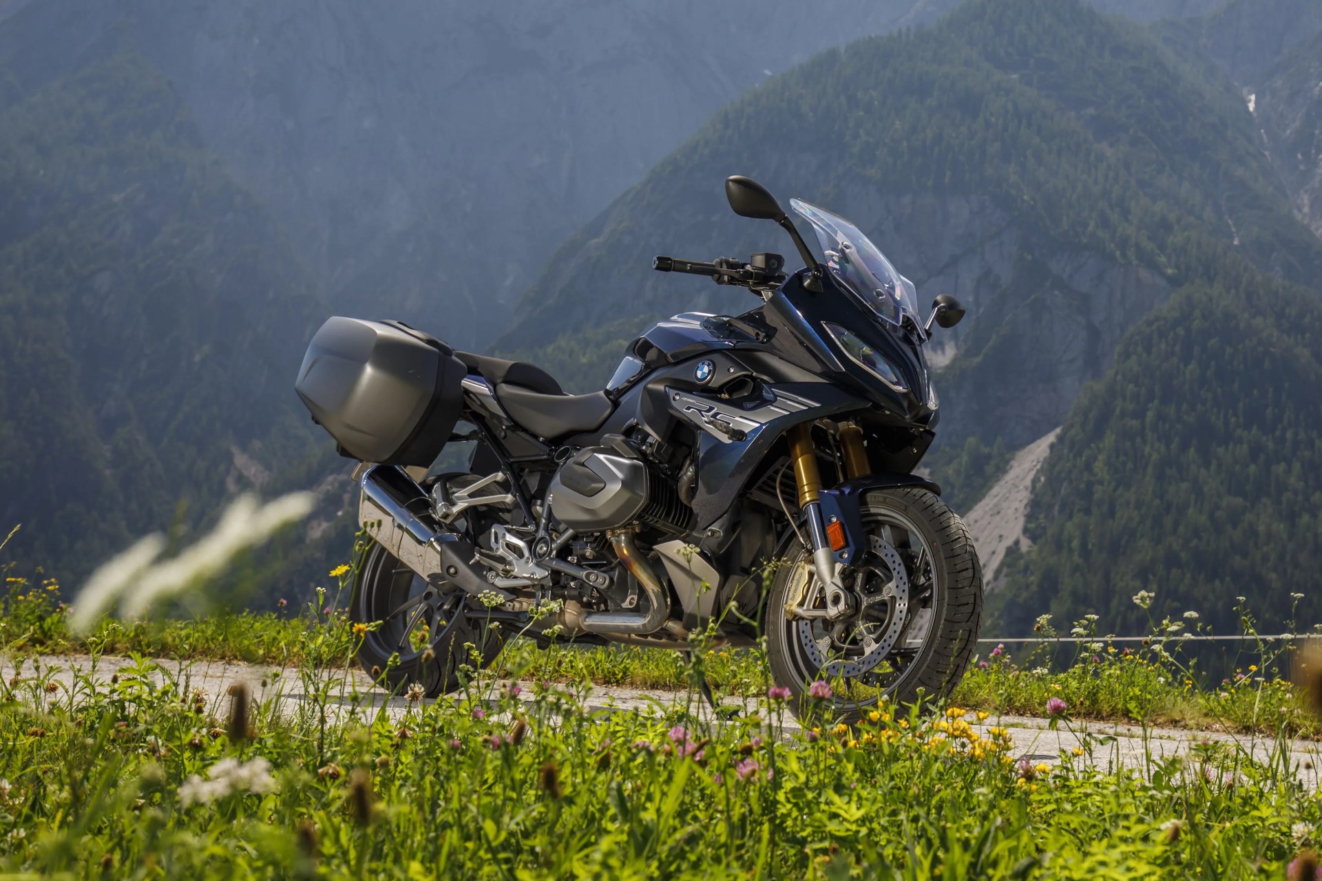 bmw r 1250 rs motorcycle parked on a country road overlooking a mountain