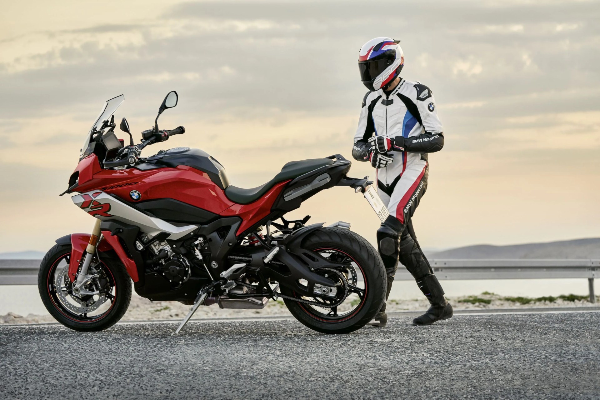 bmw s 1000 xr parked on the road in front of water