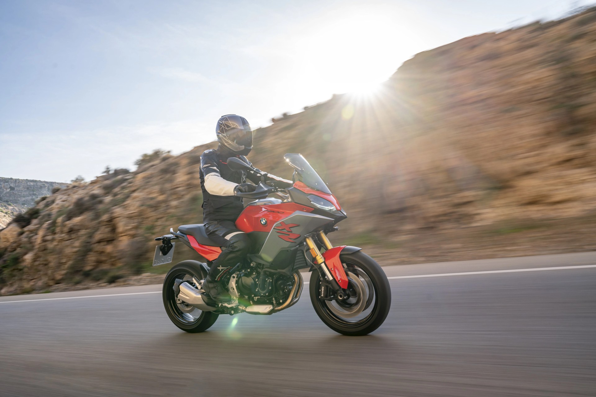 bmw f 900 xr driving on a desert mountain road