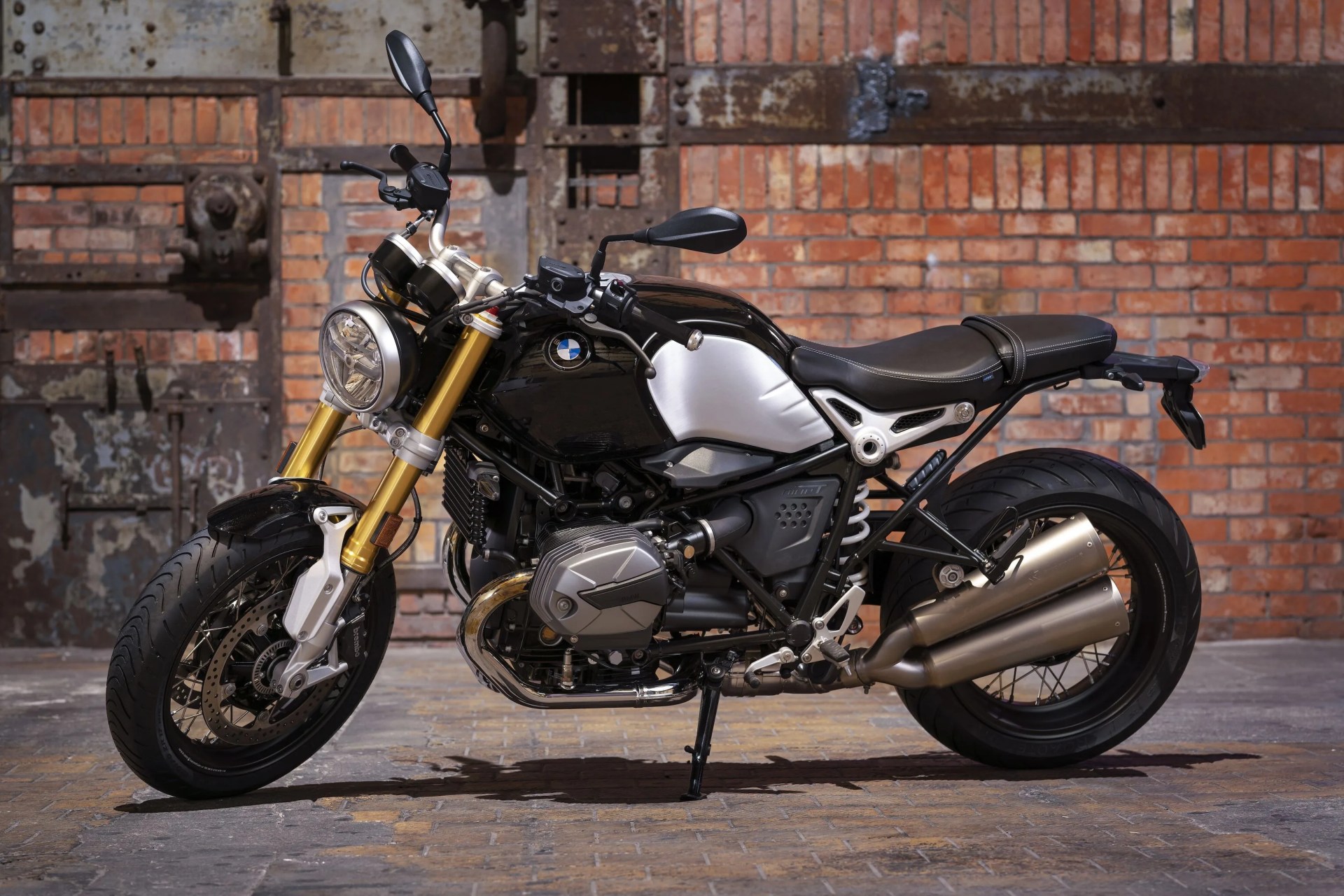 bmw r ninet motorcycle parked in front of a brick wall