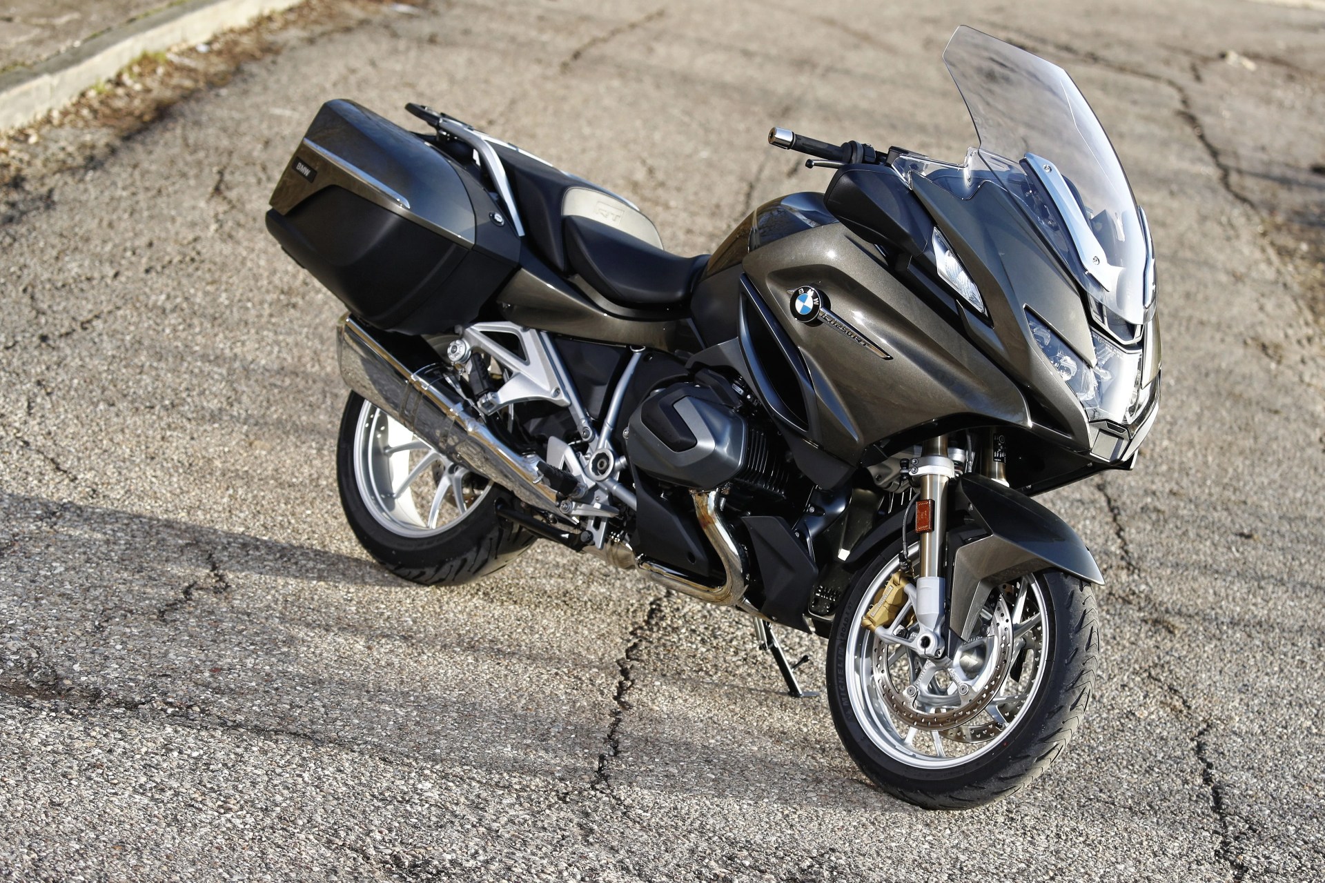 bmw r 1250 rt motorcyle parked on cracked tarmac