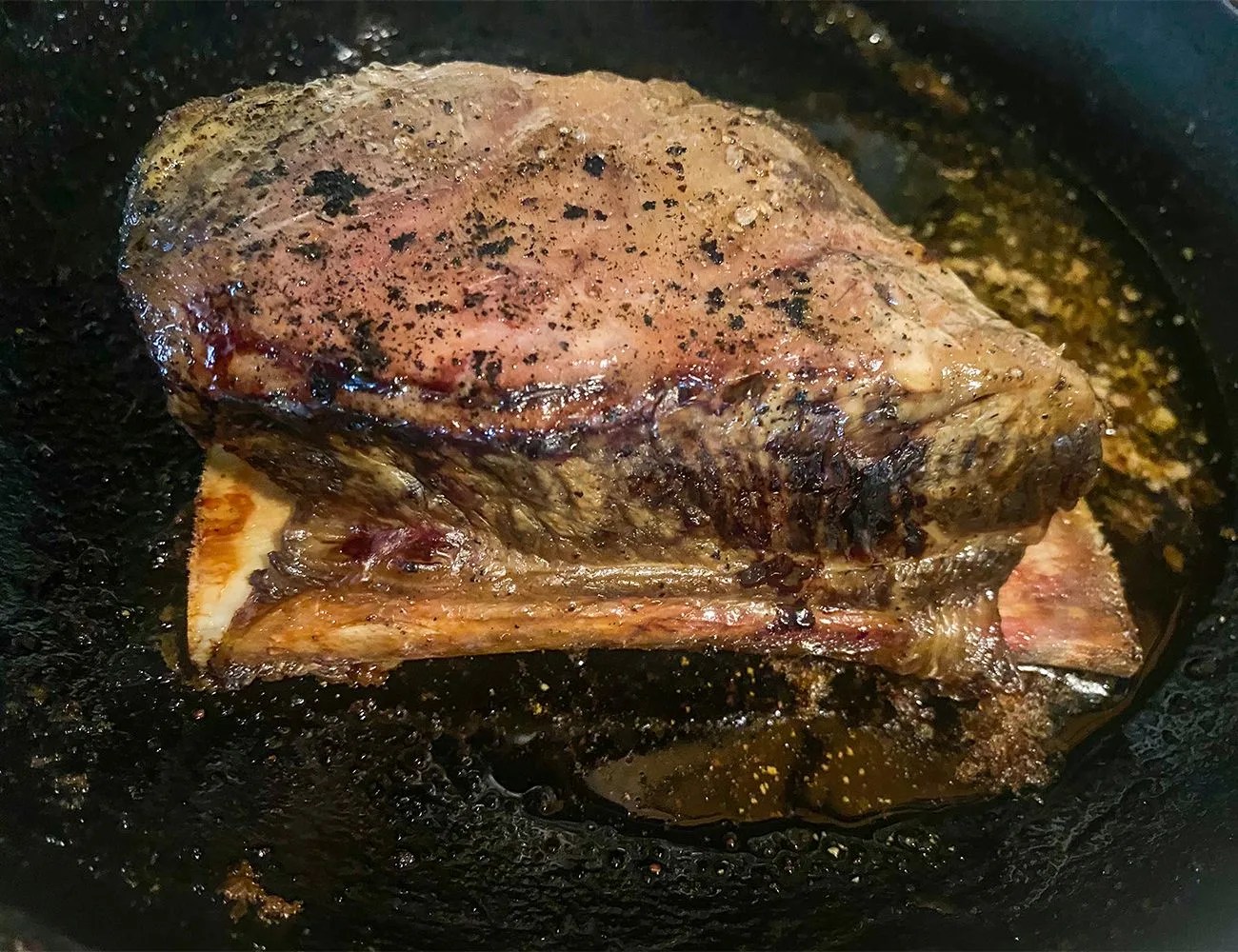 a steak cooking in a pan