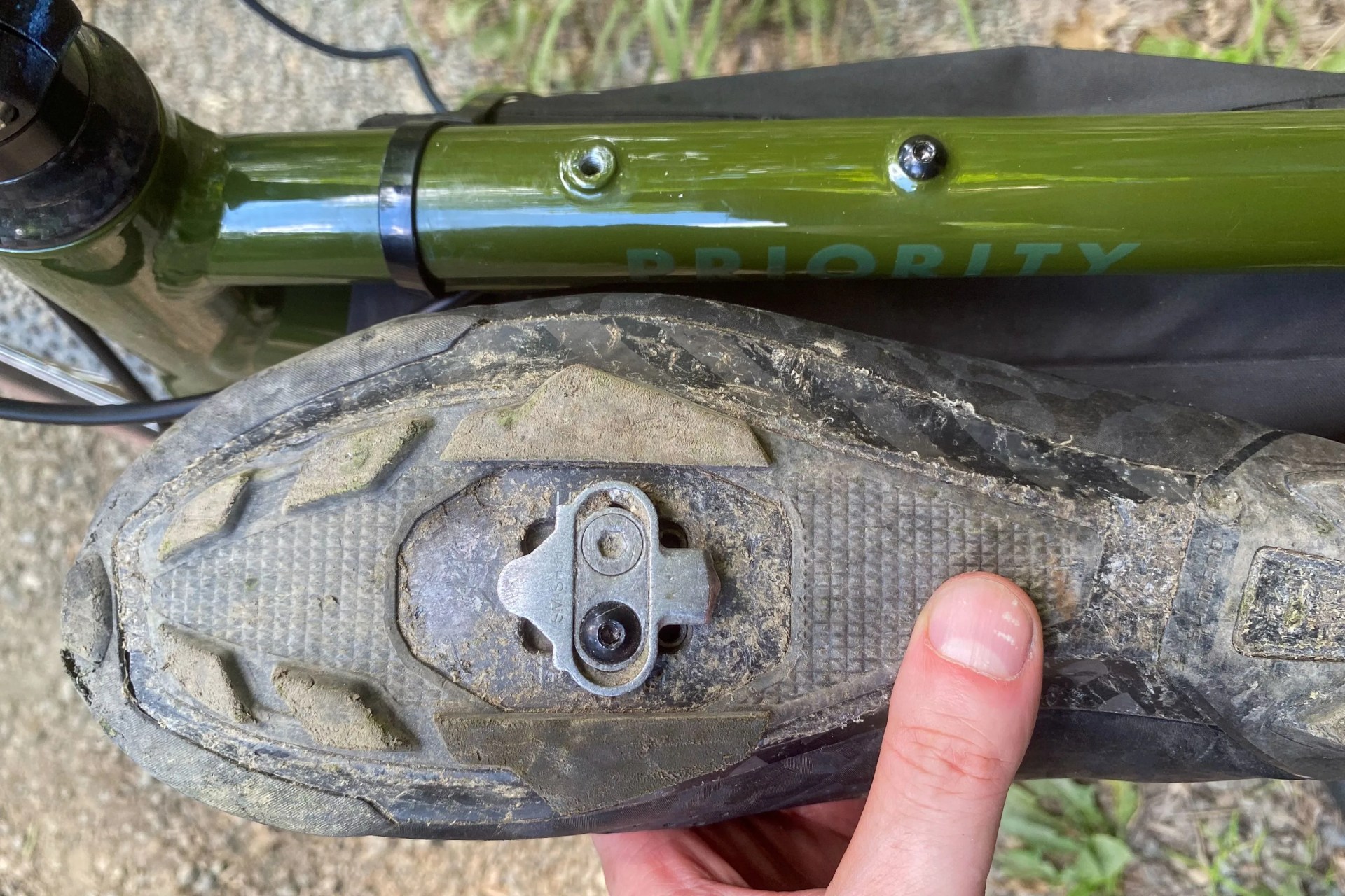 bottom of a bike shoe next to a priority apollo bike