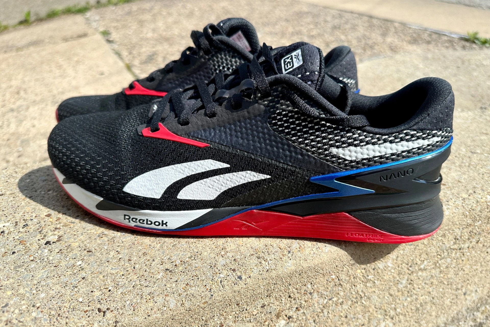 reebok shoes sitting on a sidewalk