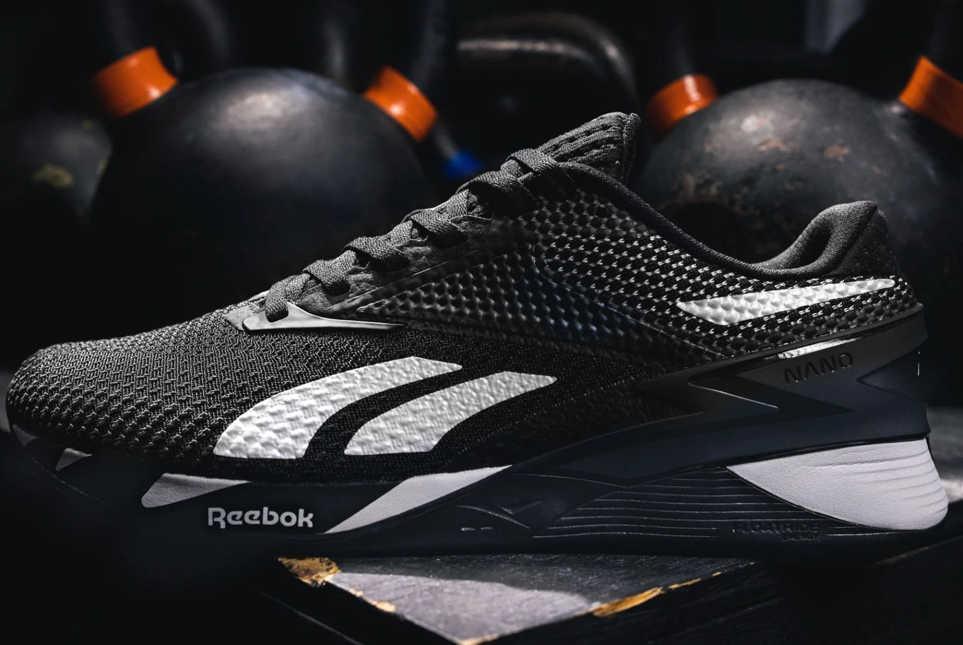 a reebok shoe in a gym sitting in front of weights
