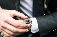 rolex gmt master ii watch on the wrist of a man in a suit