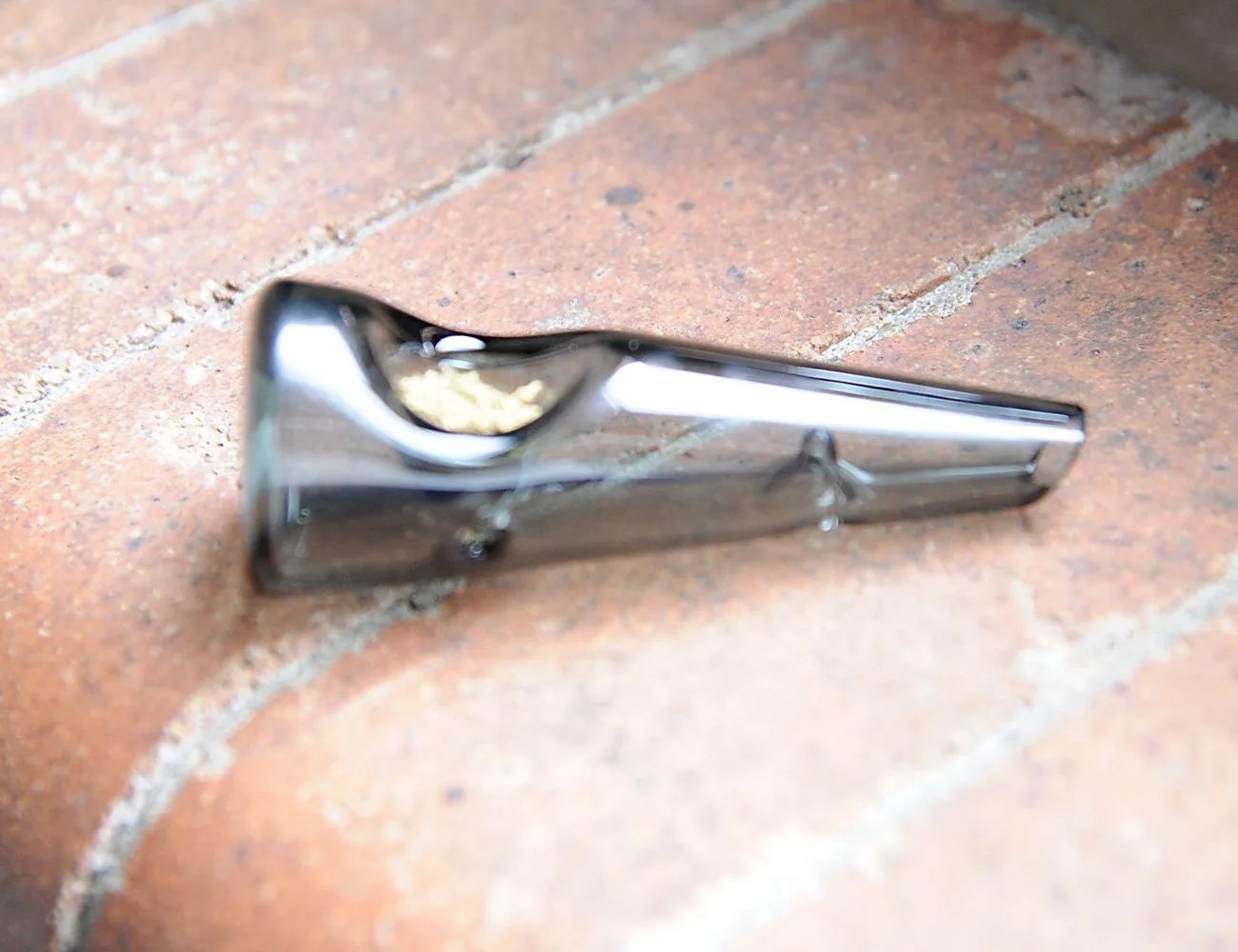 a weed pipe on a brick background