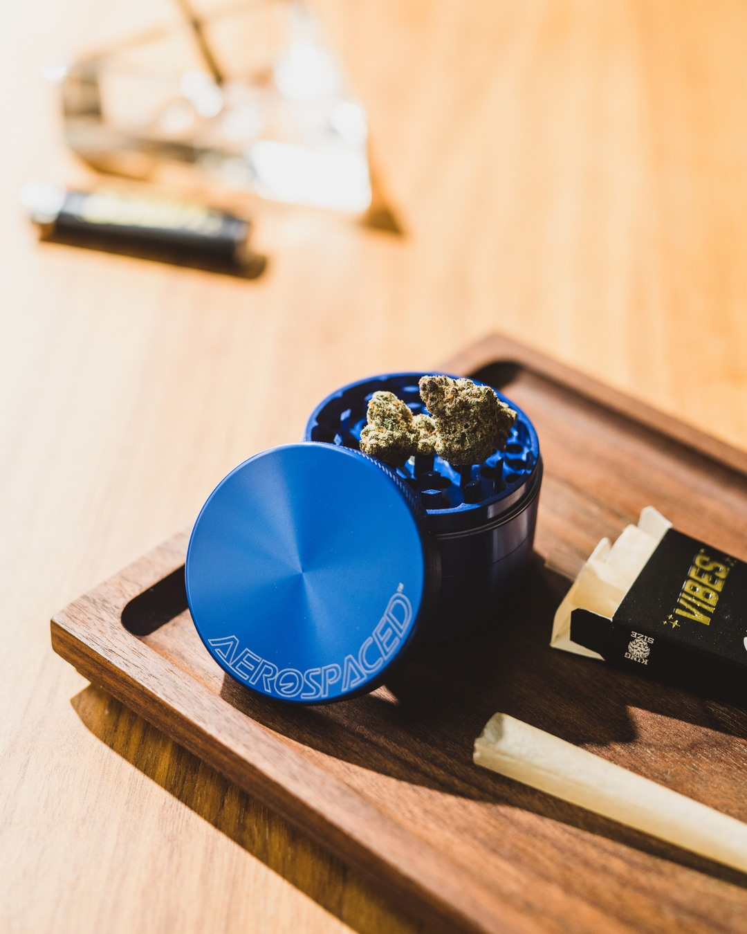 higher standards aerospaced grinder and vibes rolling papers on rolling tray