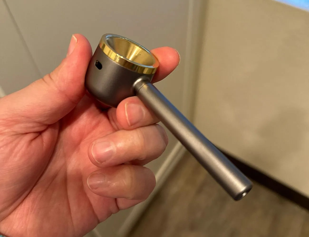 a hand holding a pipe