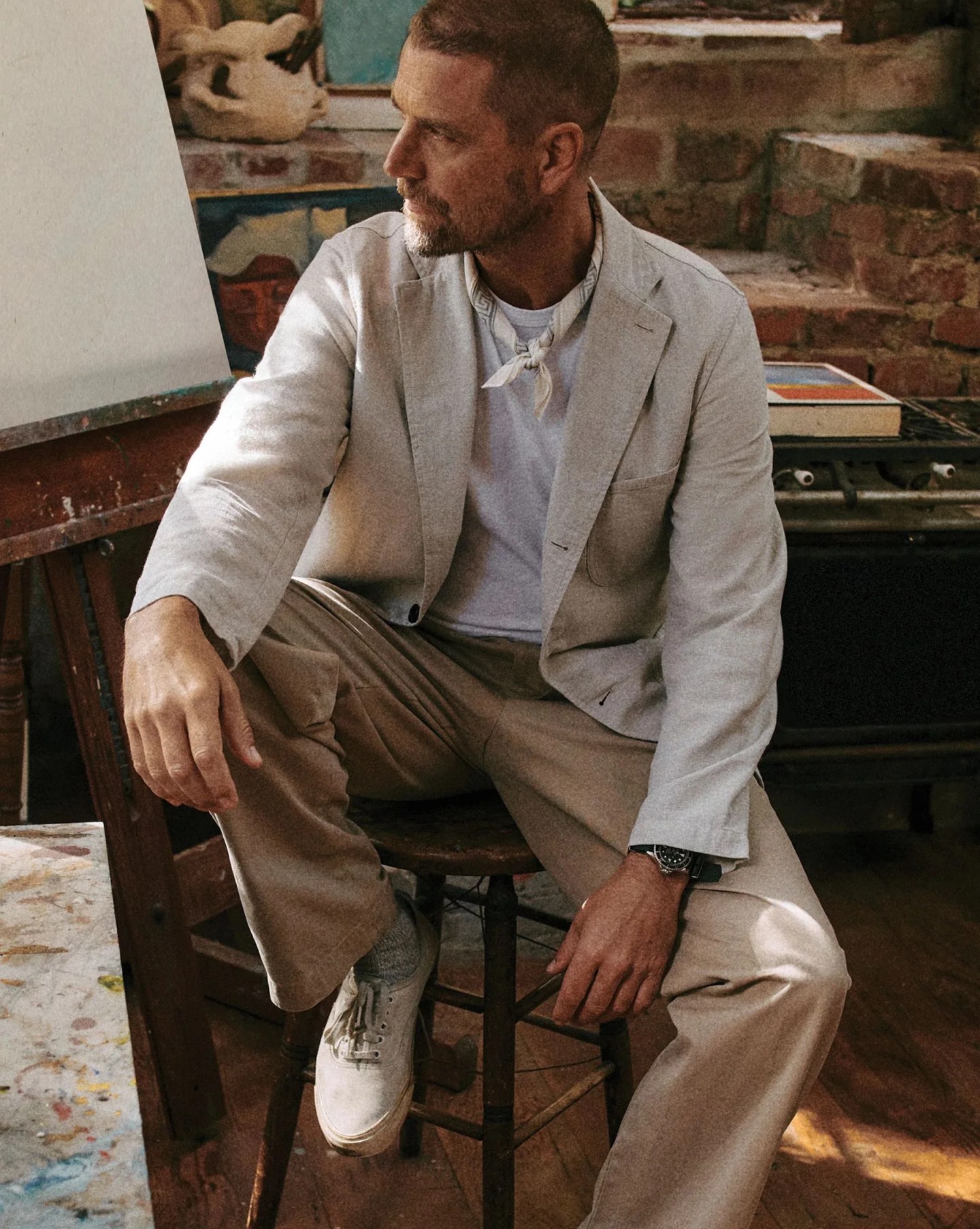 man sitting wearing buck mason suit