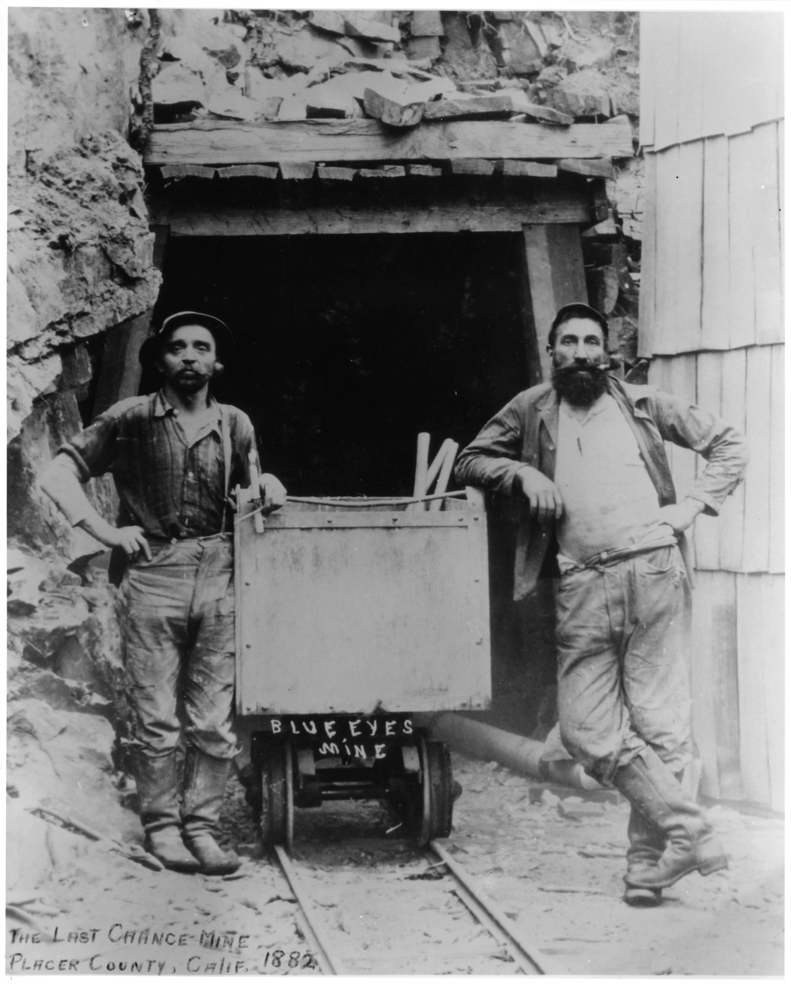 a black and white photo of 2 coal miners in california in 1882