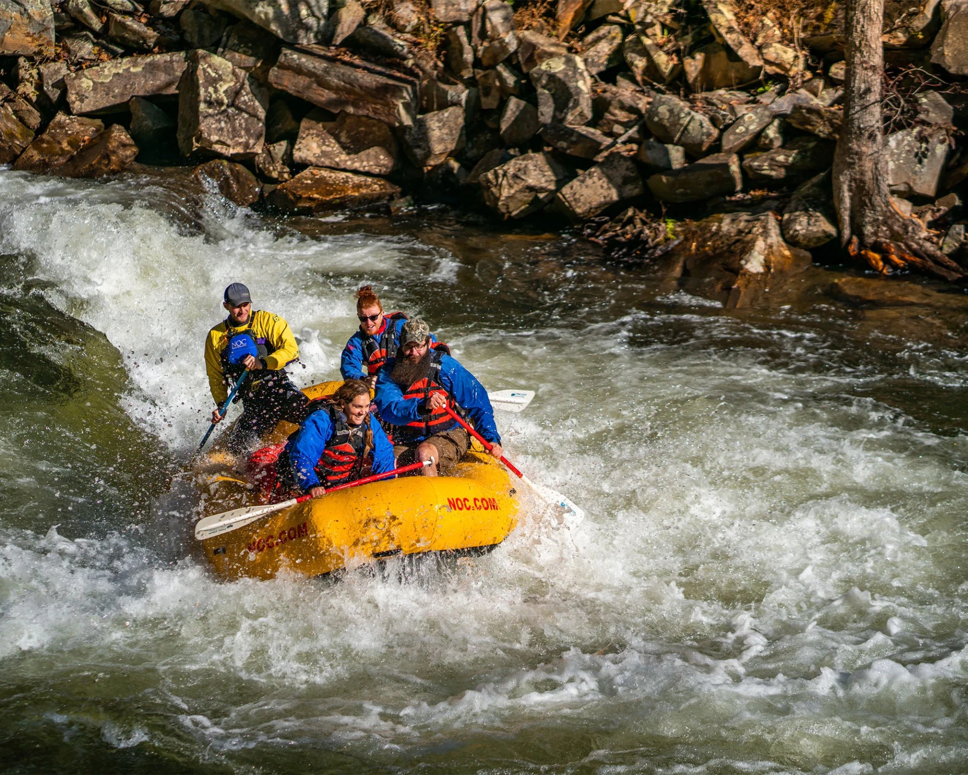 a group of individuals white water rafting