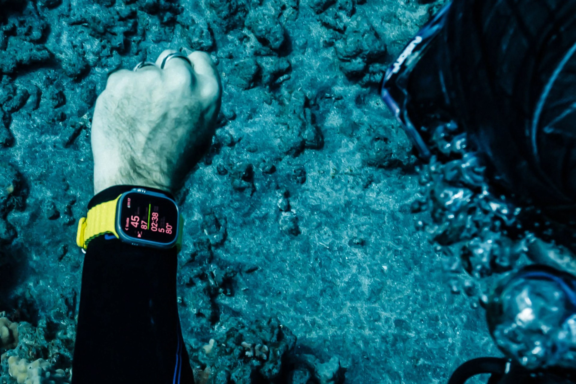 a person scuba diving wearing an apple watch ultra