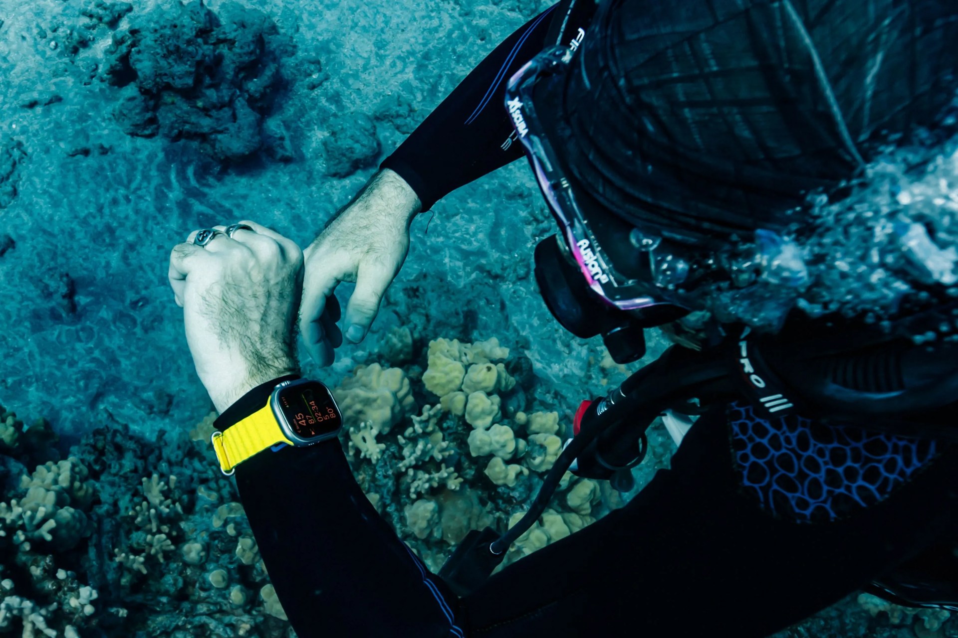 a person scuba diving wearing an apple watch ultra