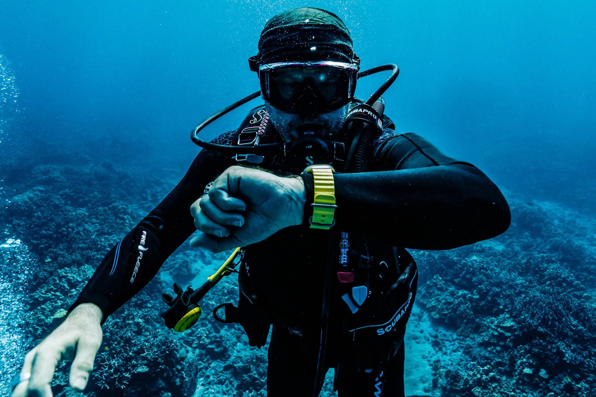 a person scuba diving wearing an apple watch ultra