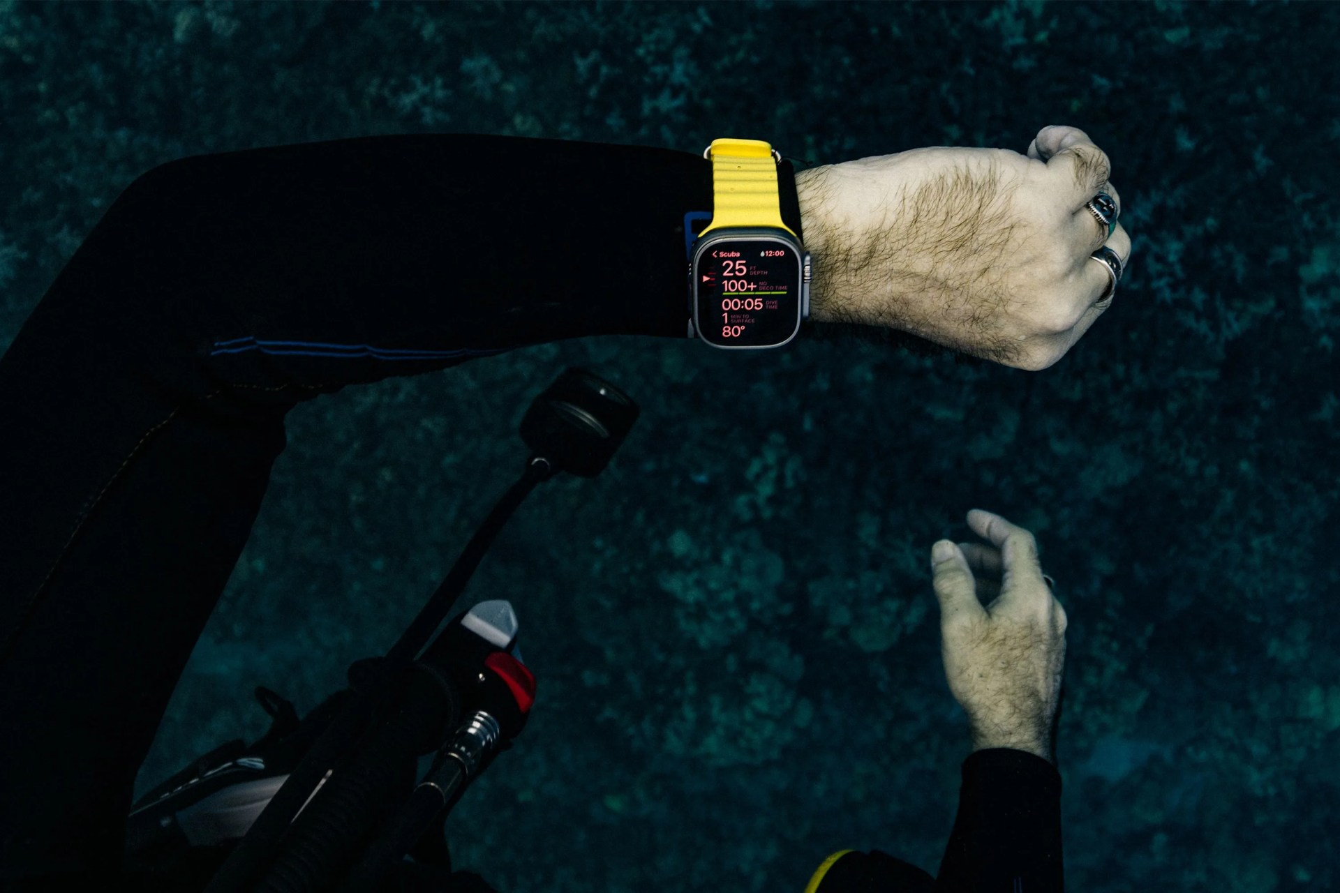 a person scuba diving wearing an apple watch ultra