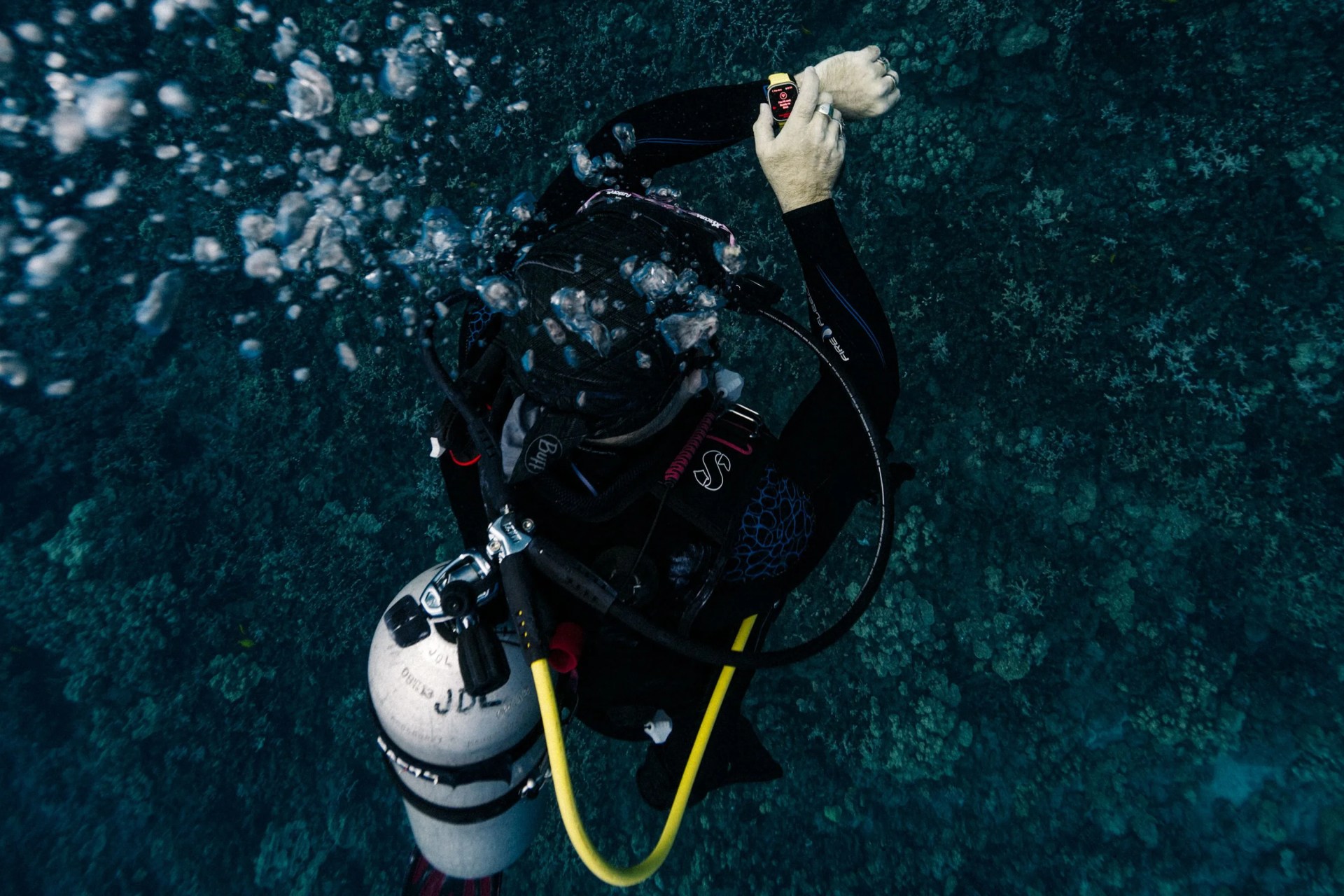 a person scuba diving wearing an apple watch ultra