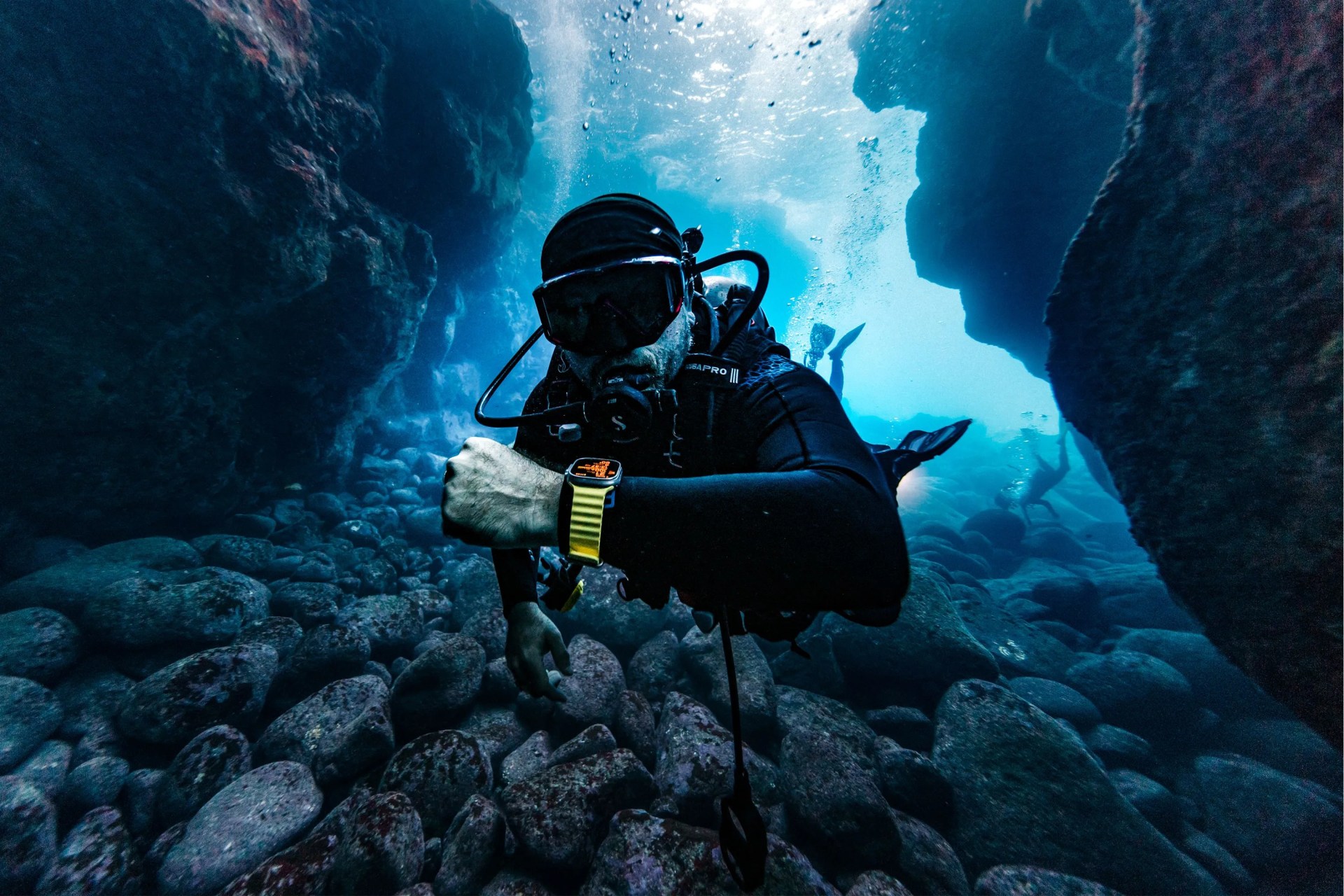 a person scuba diving wearing an apple watch ultra
