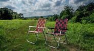 two lawn chairs in grass