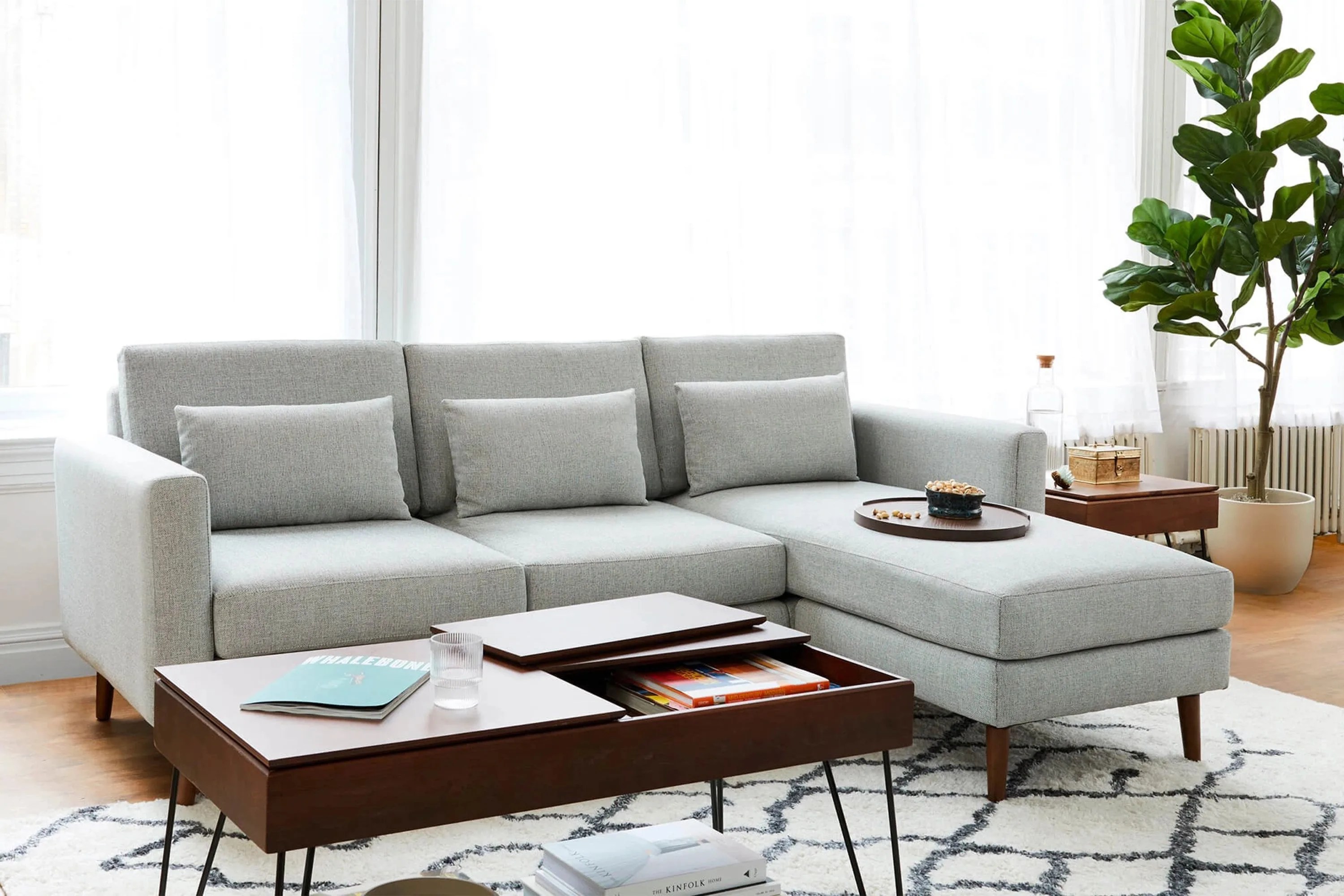 burrow nomad couch with a wooden coffee table