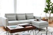 burrow nomad couch with a wooden coffee table