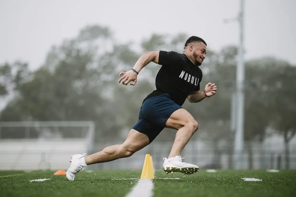 deuce vaughn practicing on a football field