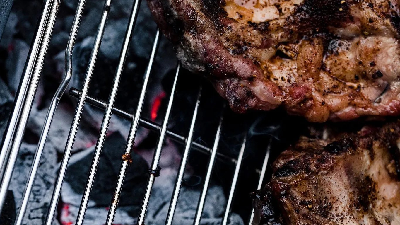 close up of meat on a charcoal grill