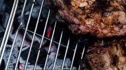 close up of meat on a charcoal grill