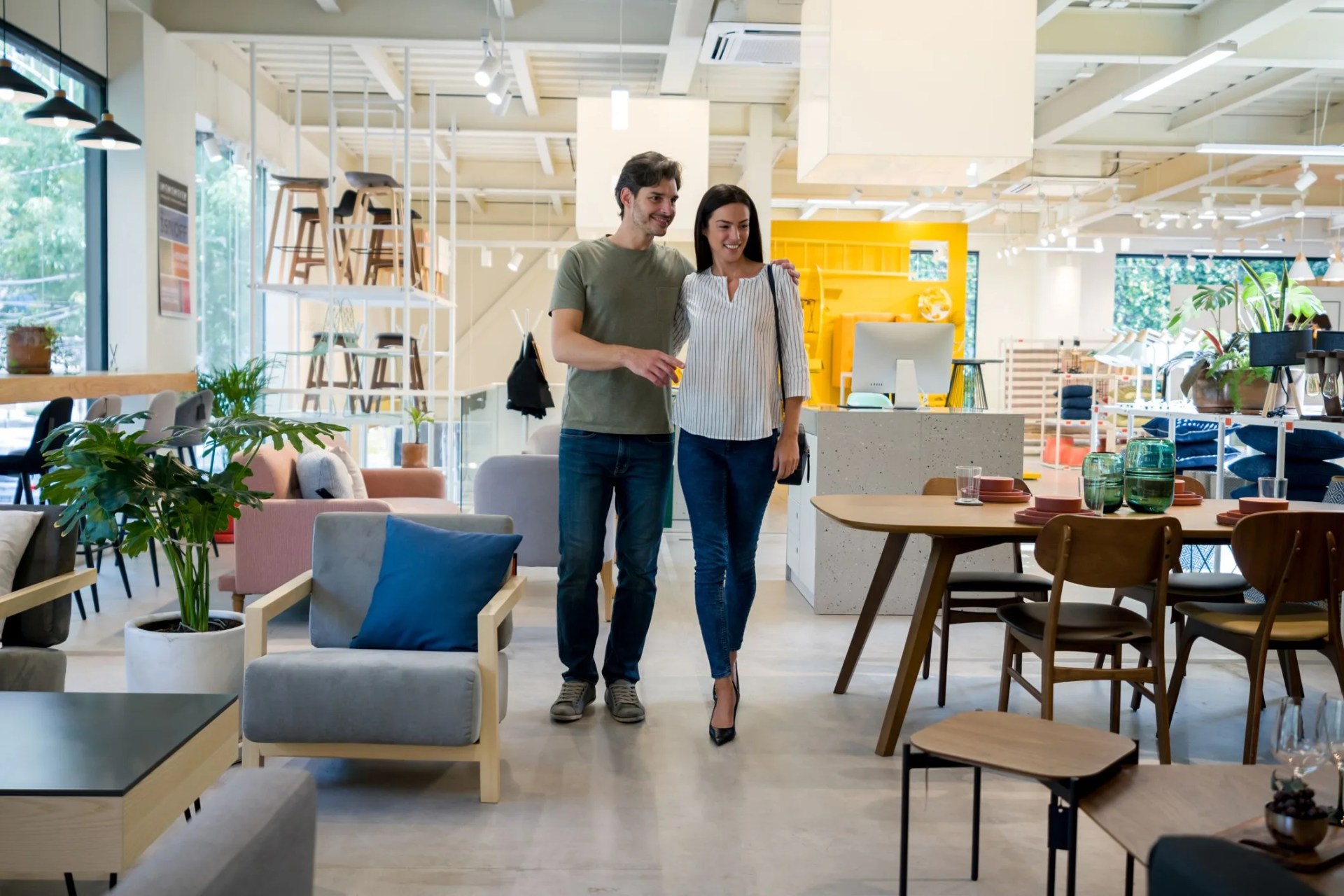 happy couple selecting items for the wedding registry at a furniture store