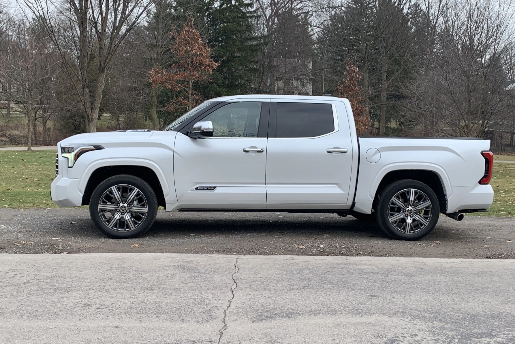 toyota tundra from the side in front of a park