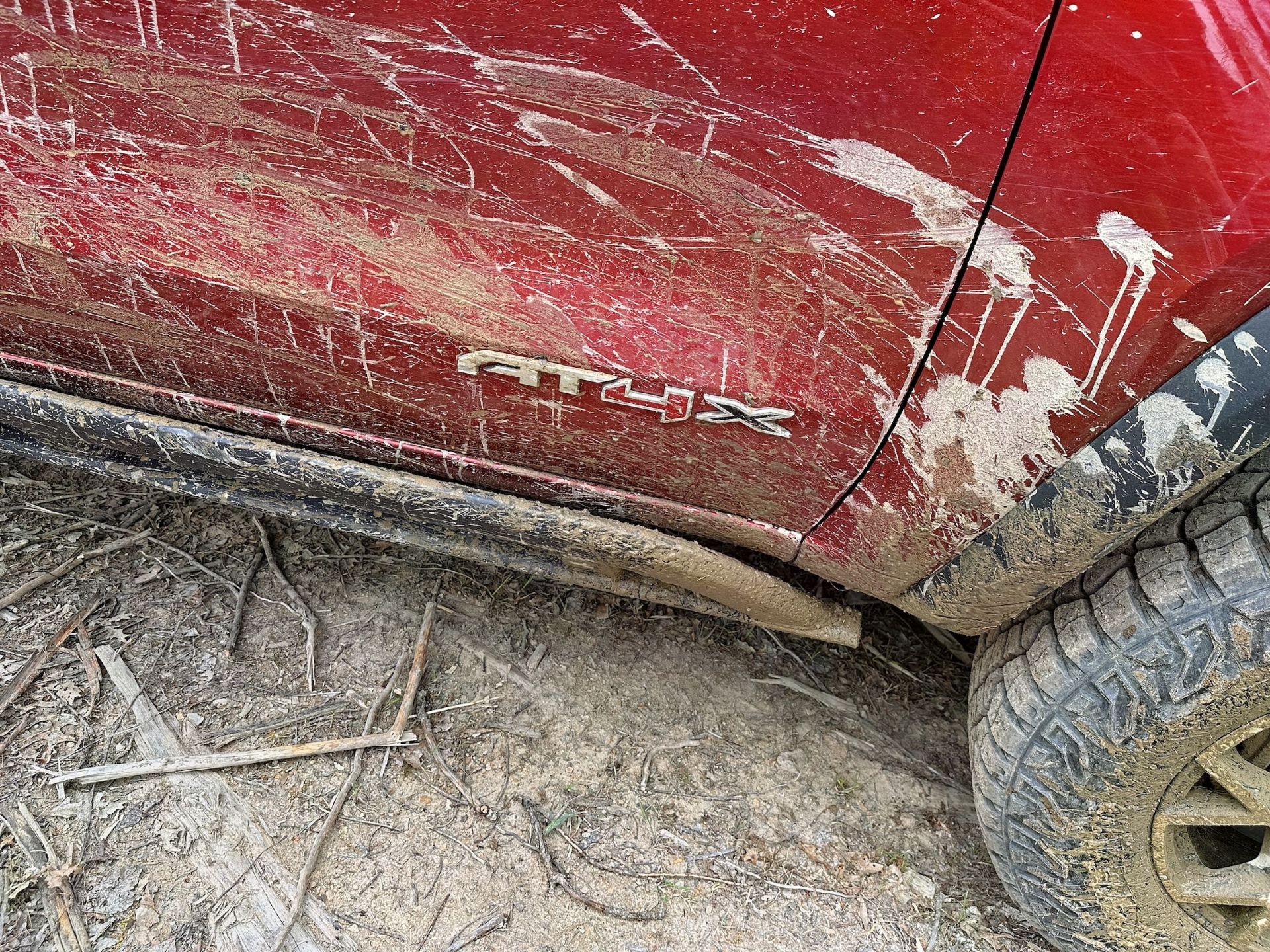 gmc canyon at4 door badge covered in mud