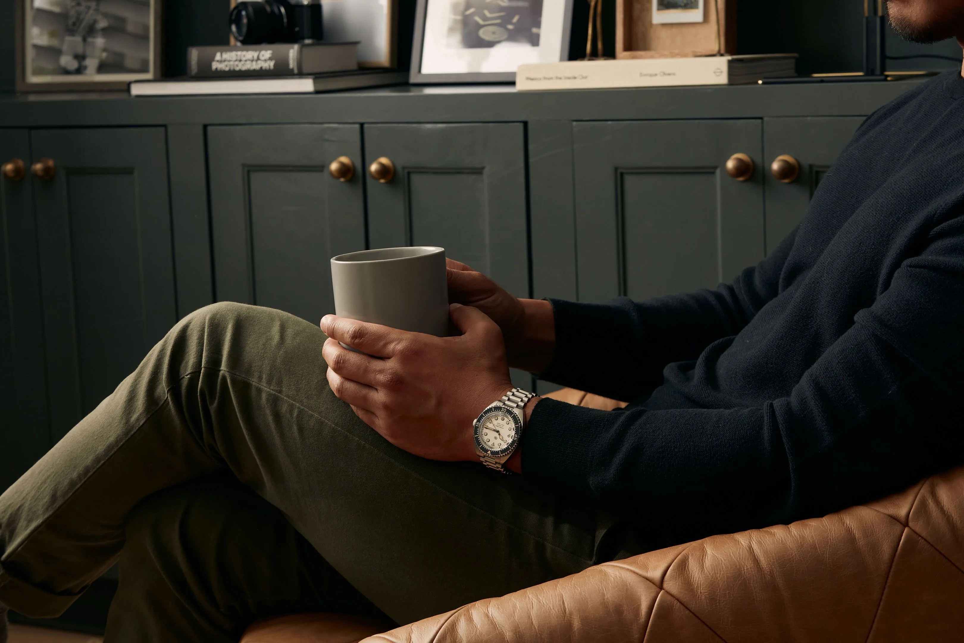 man sitting down wearing jack mason hydro timer watch
