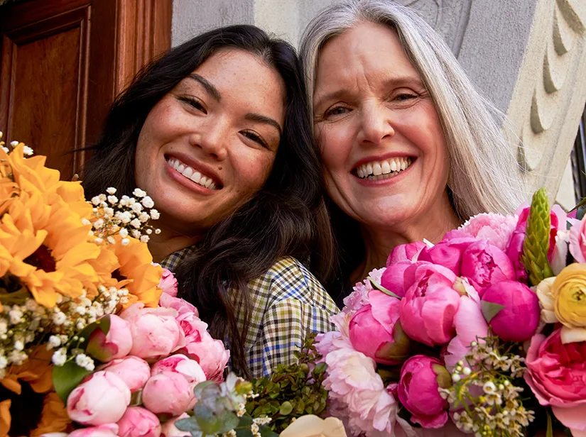 two women holding bouquets