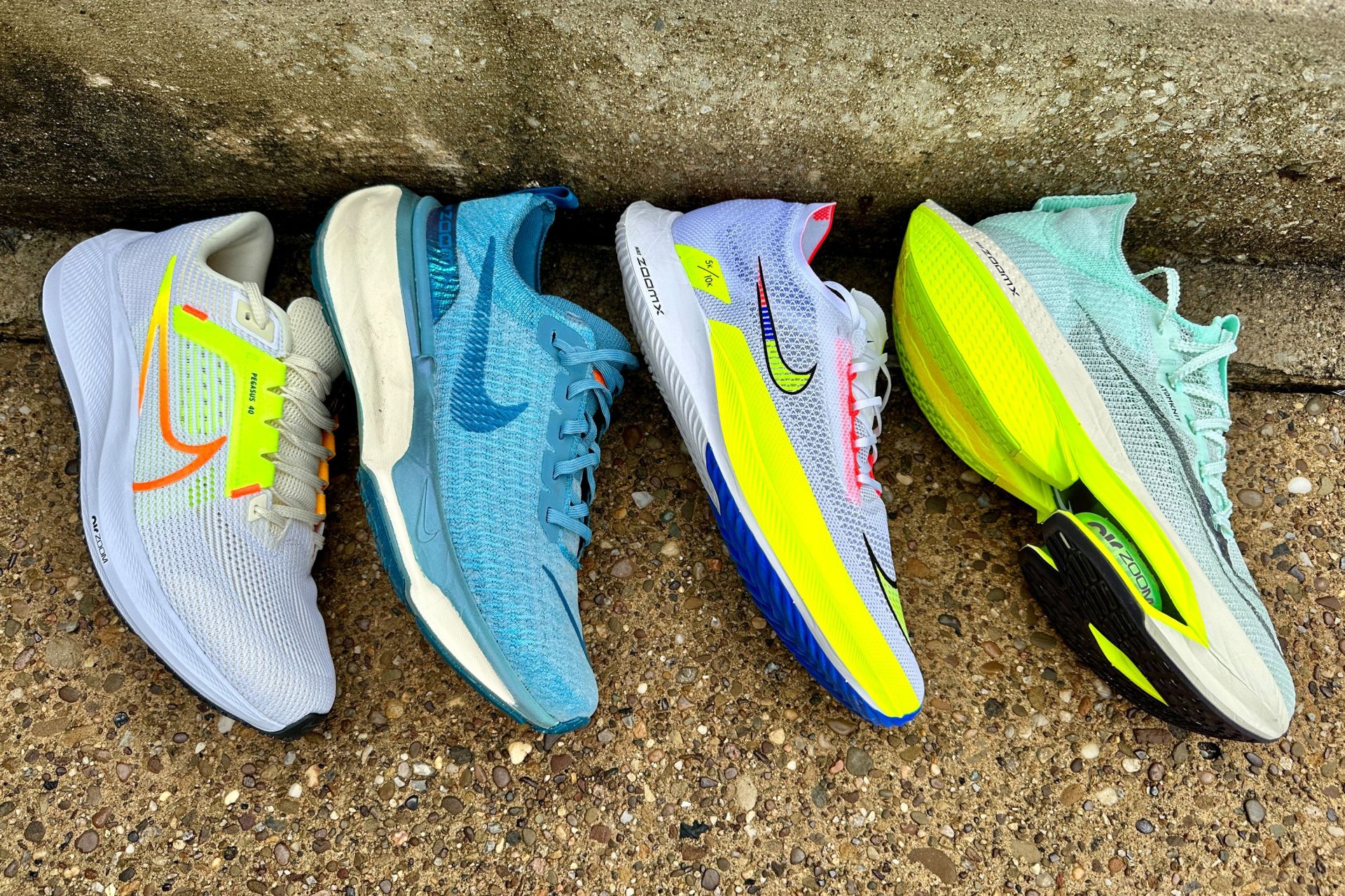 4 nike shoes on a curb