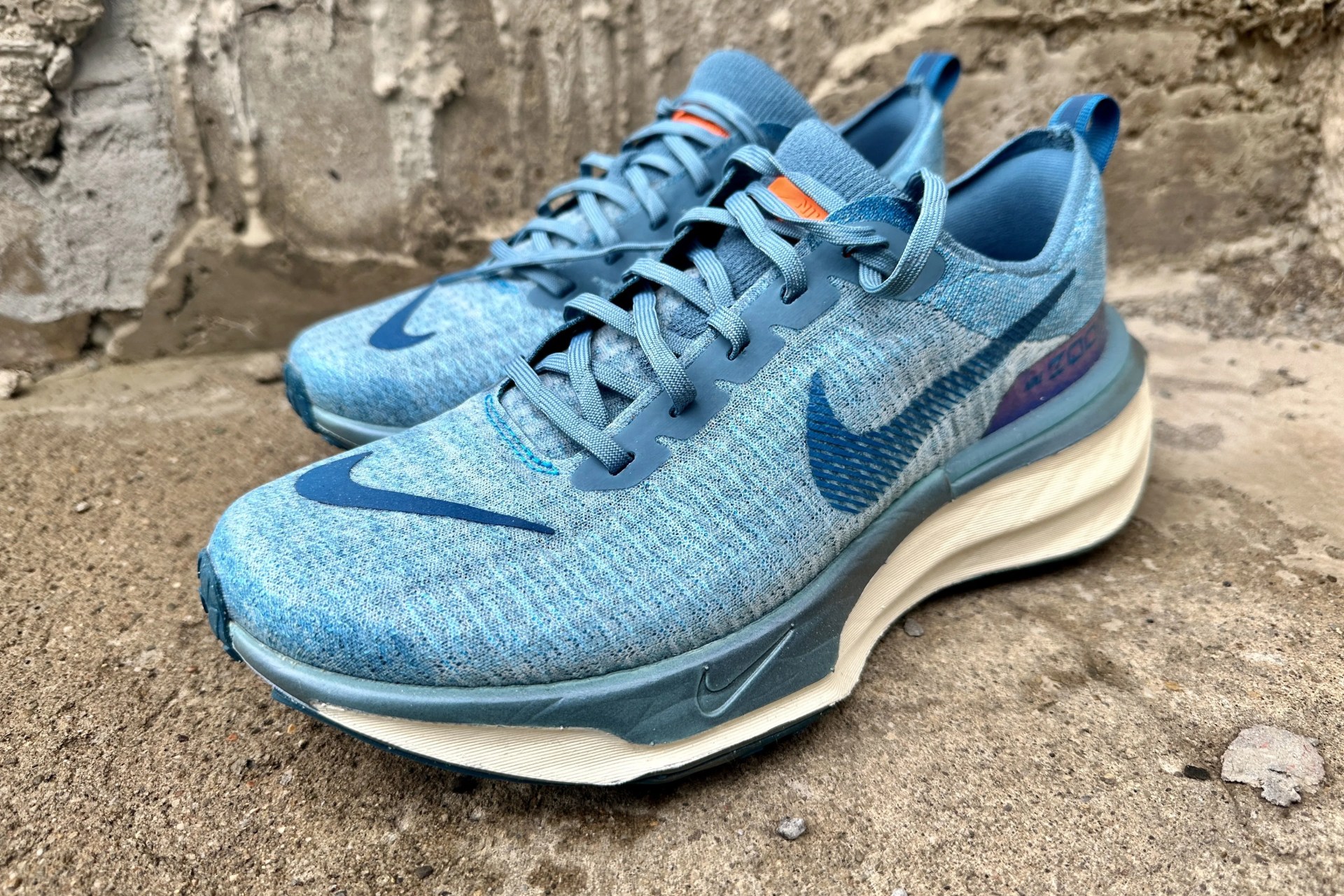 a pair of nike shoes on a sidewalk