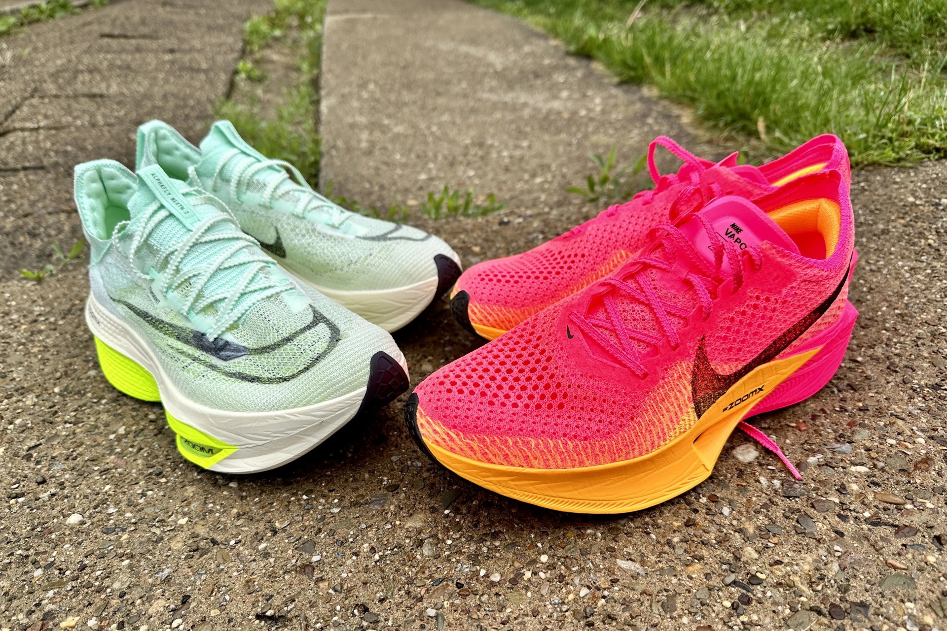 two pairs of nike shoes on a sidewalk