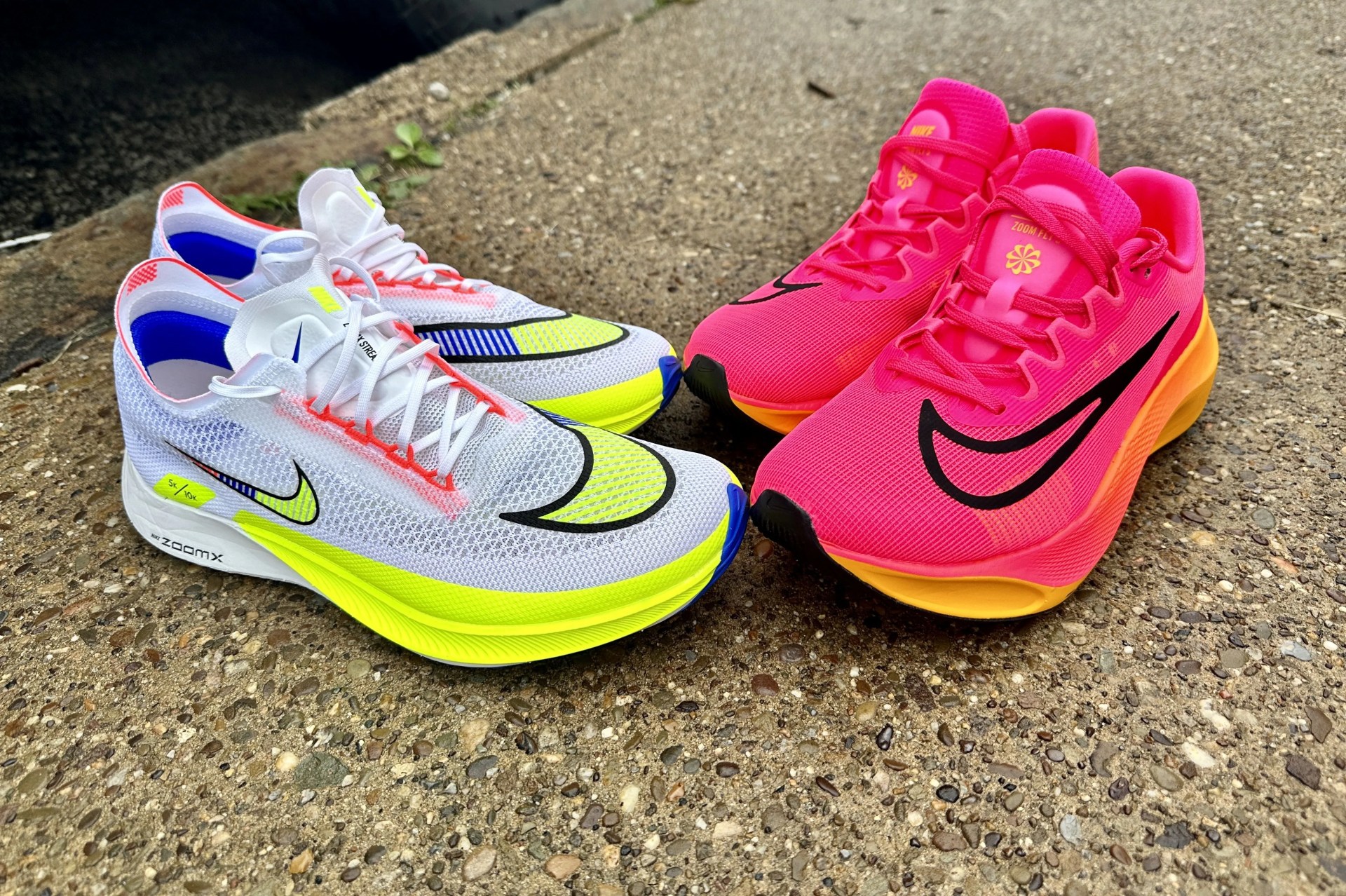 two pairs of nike shoes on a sidewalk