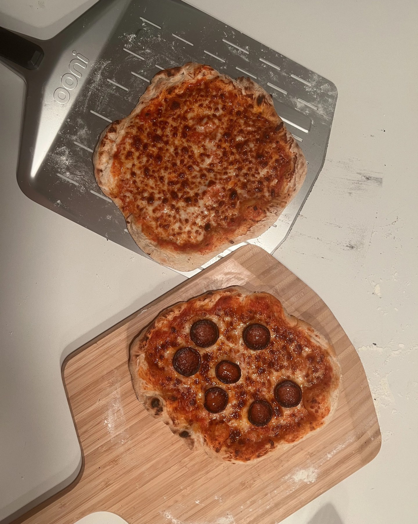 two pizzas cooked in an ooni volt 12 electric pizza oven