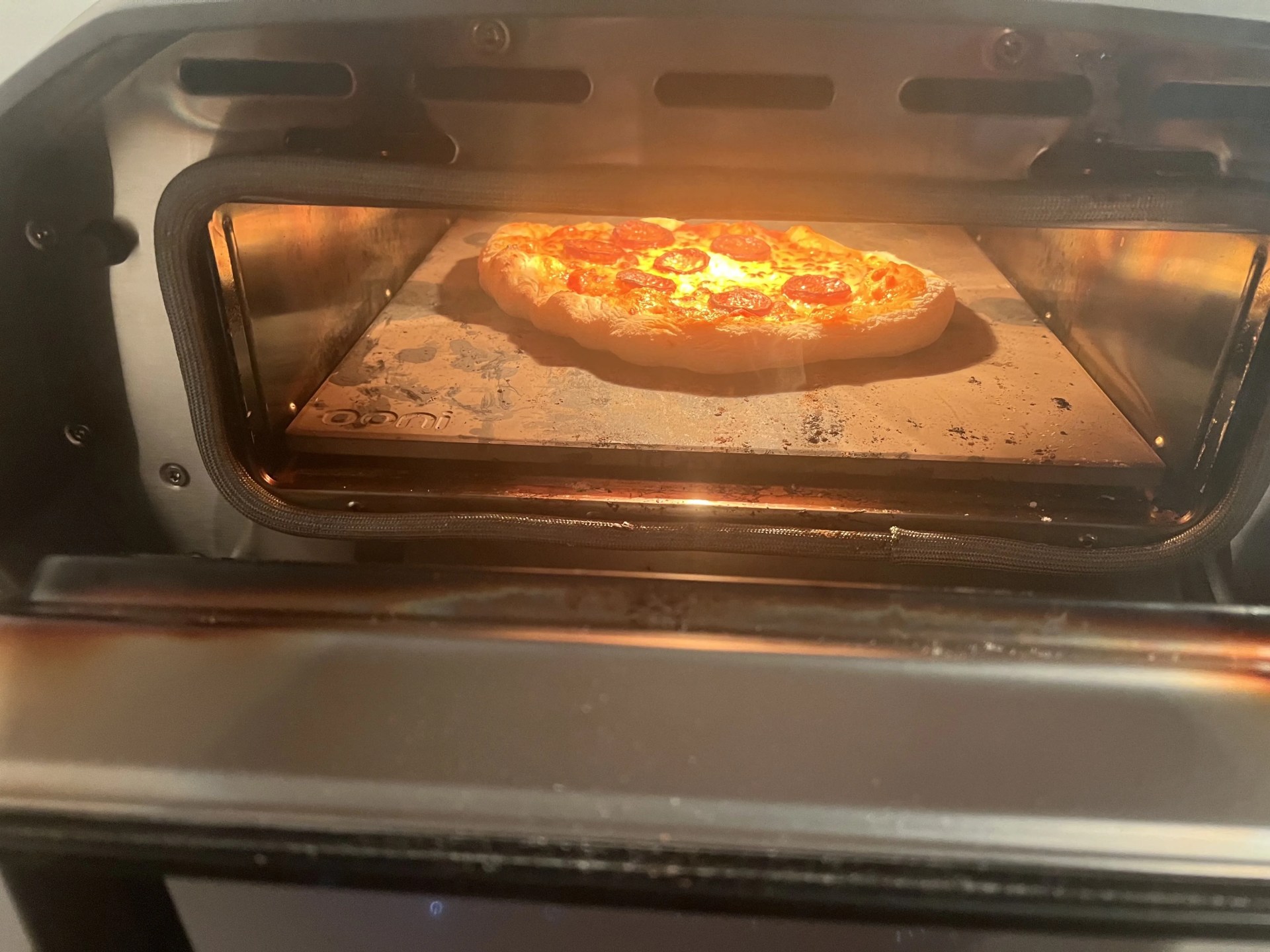a pizza cooks inside the ooni volt 12 electric pizza oven