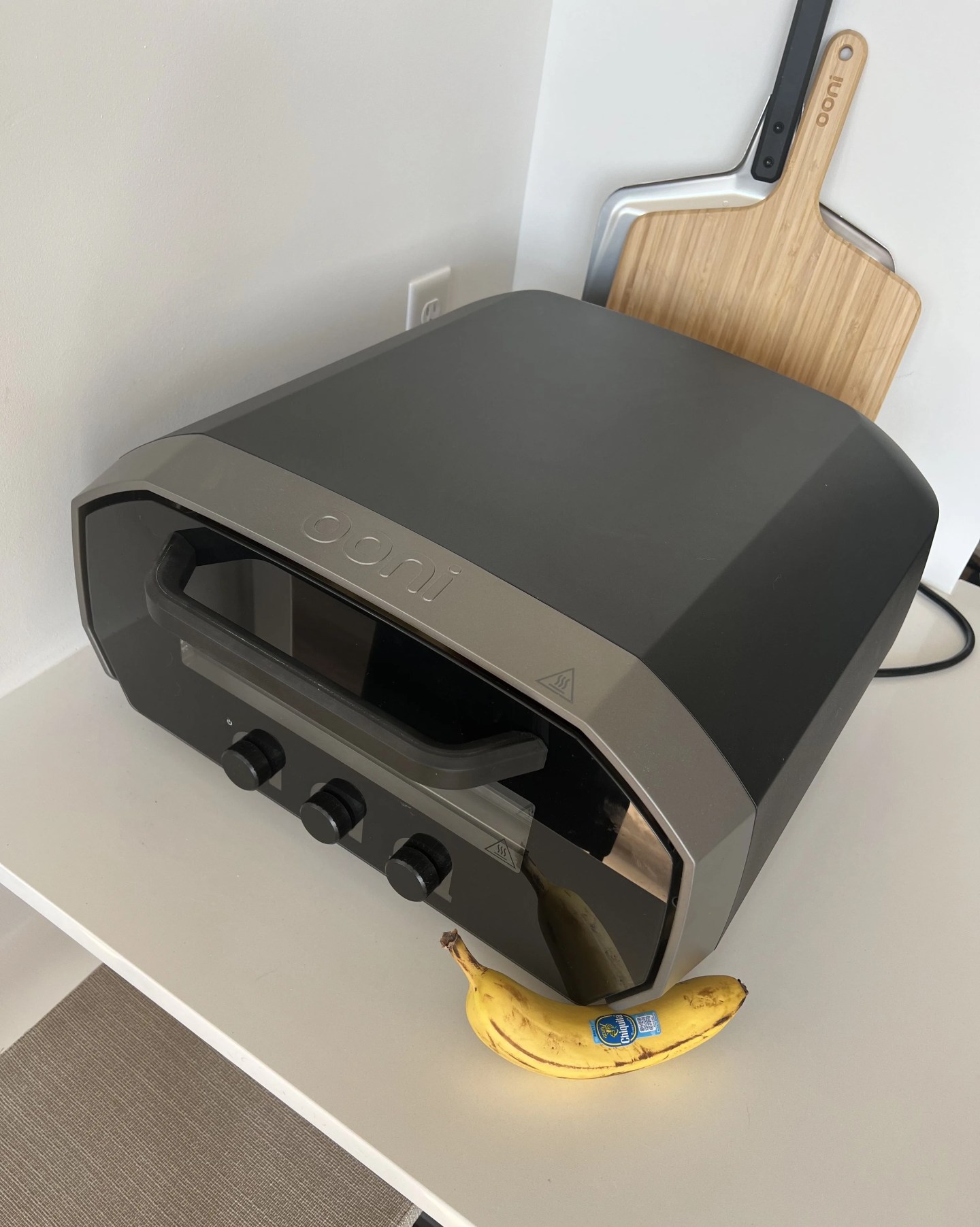 ooni volt 12 electric pizza oven next to a banana