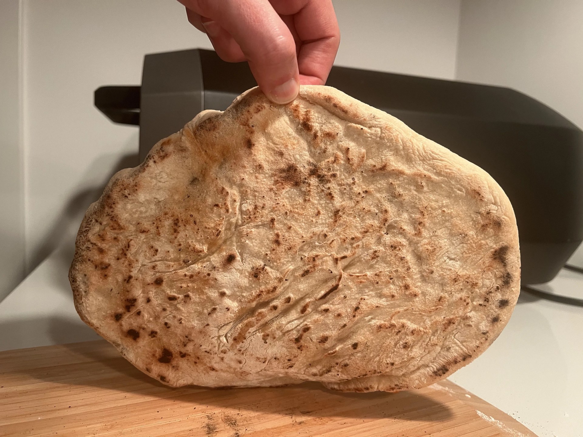 the crust of a pizza cooked in the ooni volt electric pizza oven