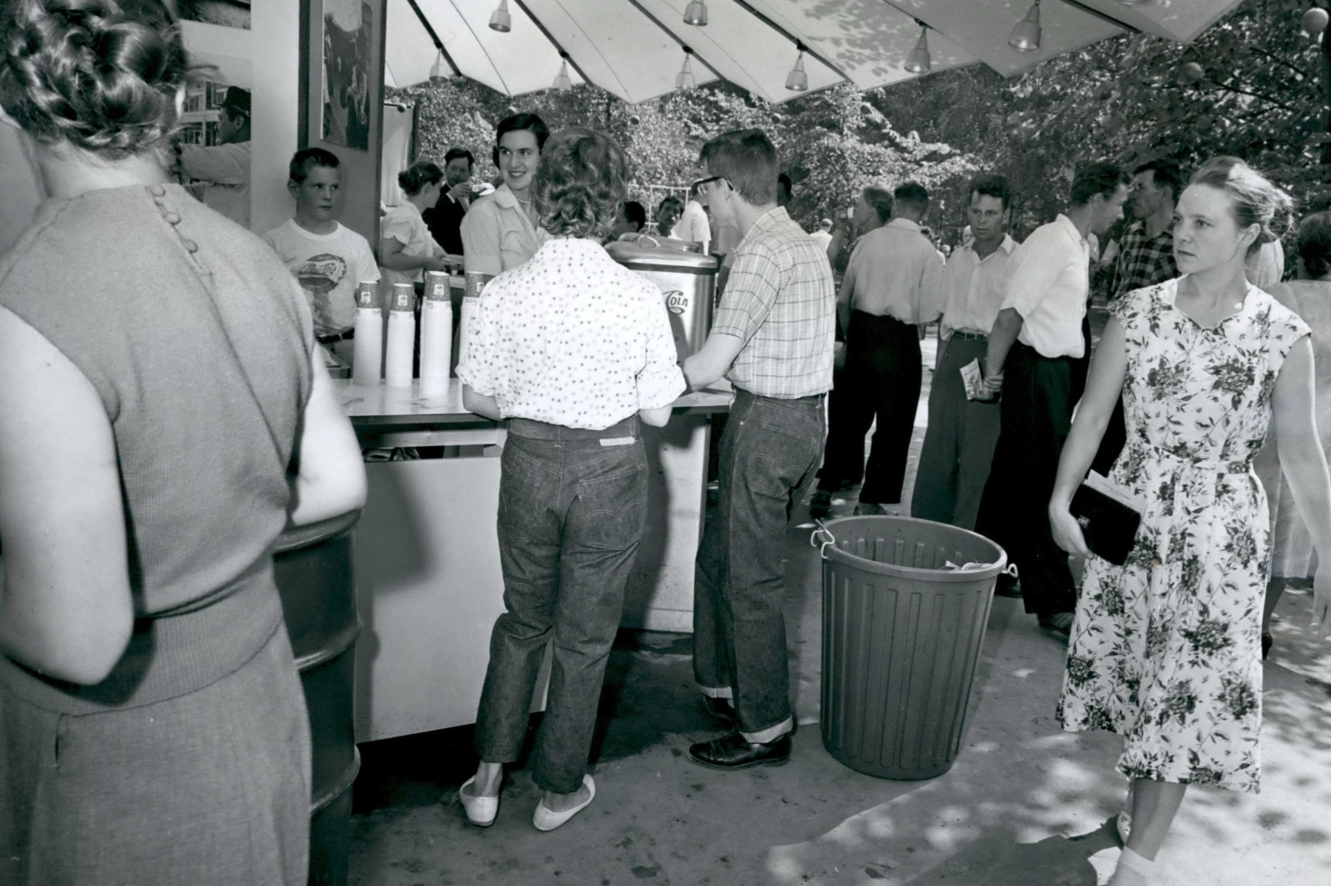 an old black and white image of people wearing jeans with a white tshirt